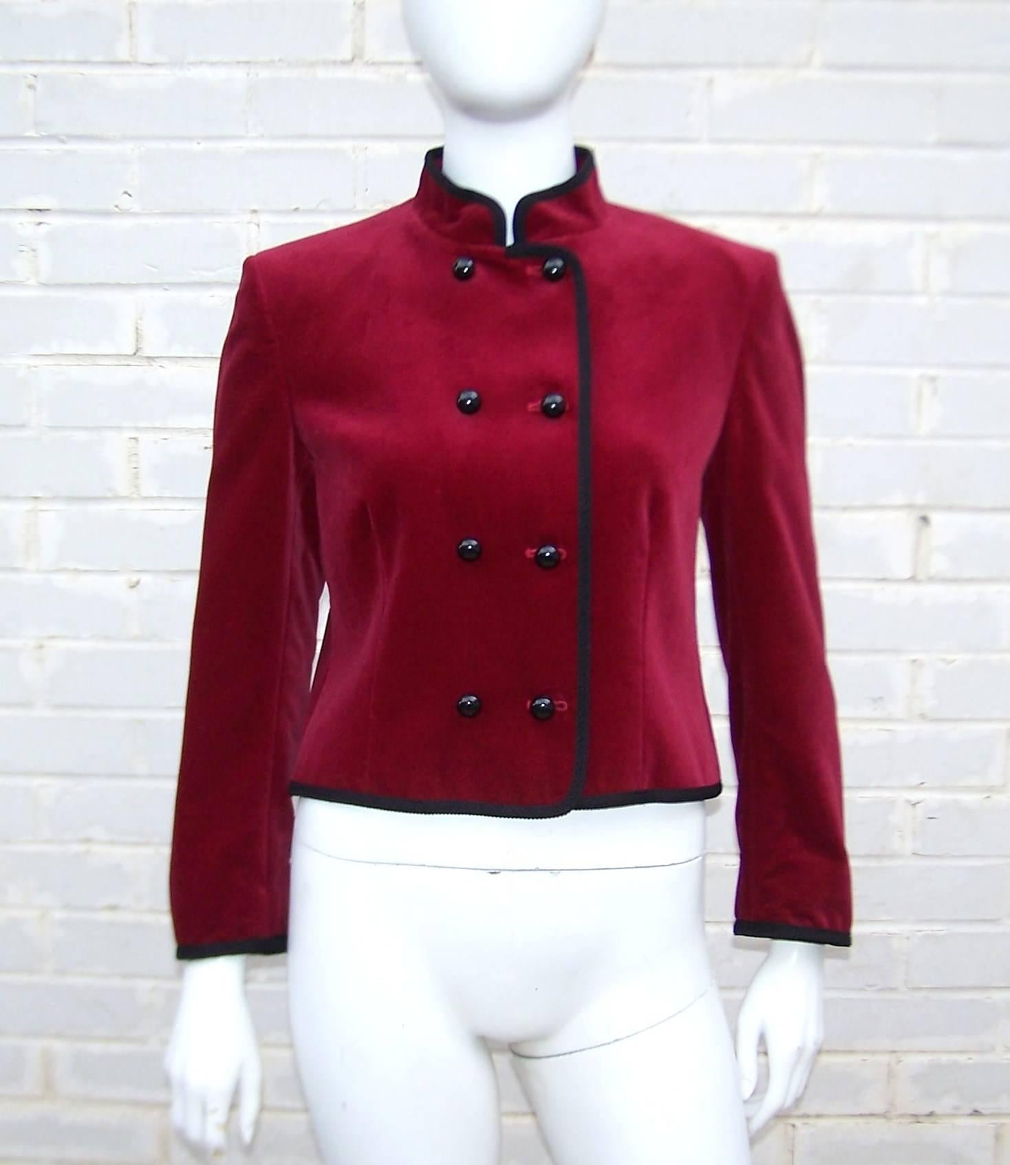 Jaeger has been making classic clothing since the turn of the 20th century.  This adorable velveteen jacket is reminiscent of an old school bellhop's topper.  The structured double breasted construction buttons at the front with shiny dome buttons