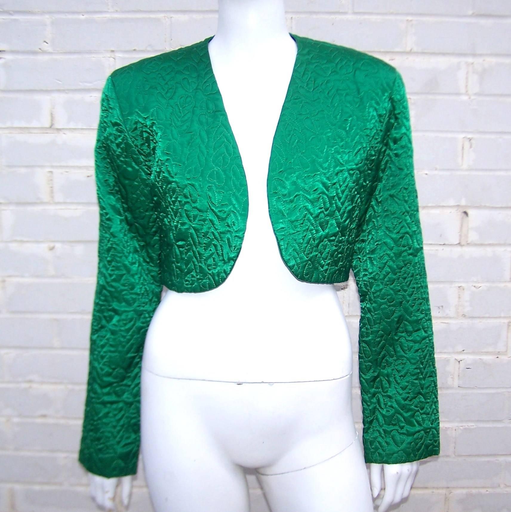 This C.1980 Perry Ellis jacket is a beautiful jewel tone color with quilting for added visual interest.  The boxy cropped silhouette is structured at the shoulders but comfortably open through the bodice designed to be worn without closure.  The