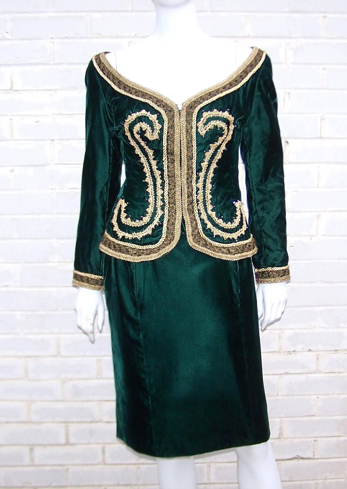 This 1980's skirt suit is reminiscent of luxe renaissance era clothing.  The heavily embellished off-shoulder jacket is trimmed in gold braiding with swirls of gold and black beading.  It hooks at the front with flesh tone satin lining, boning and