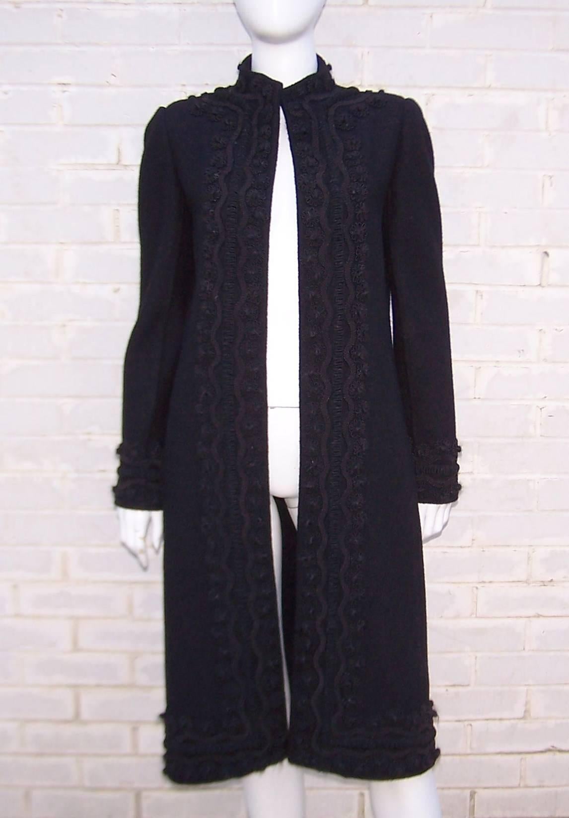 Oh the luxury of a beautifully appointed Oscar De La Renta coat!  This ladylike coat is designed with black boucle wool and trimmed at the neckline, shoulder and cuffs with Victorian influenced passementerie decoration that adds visual interest and