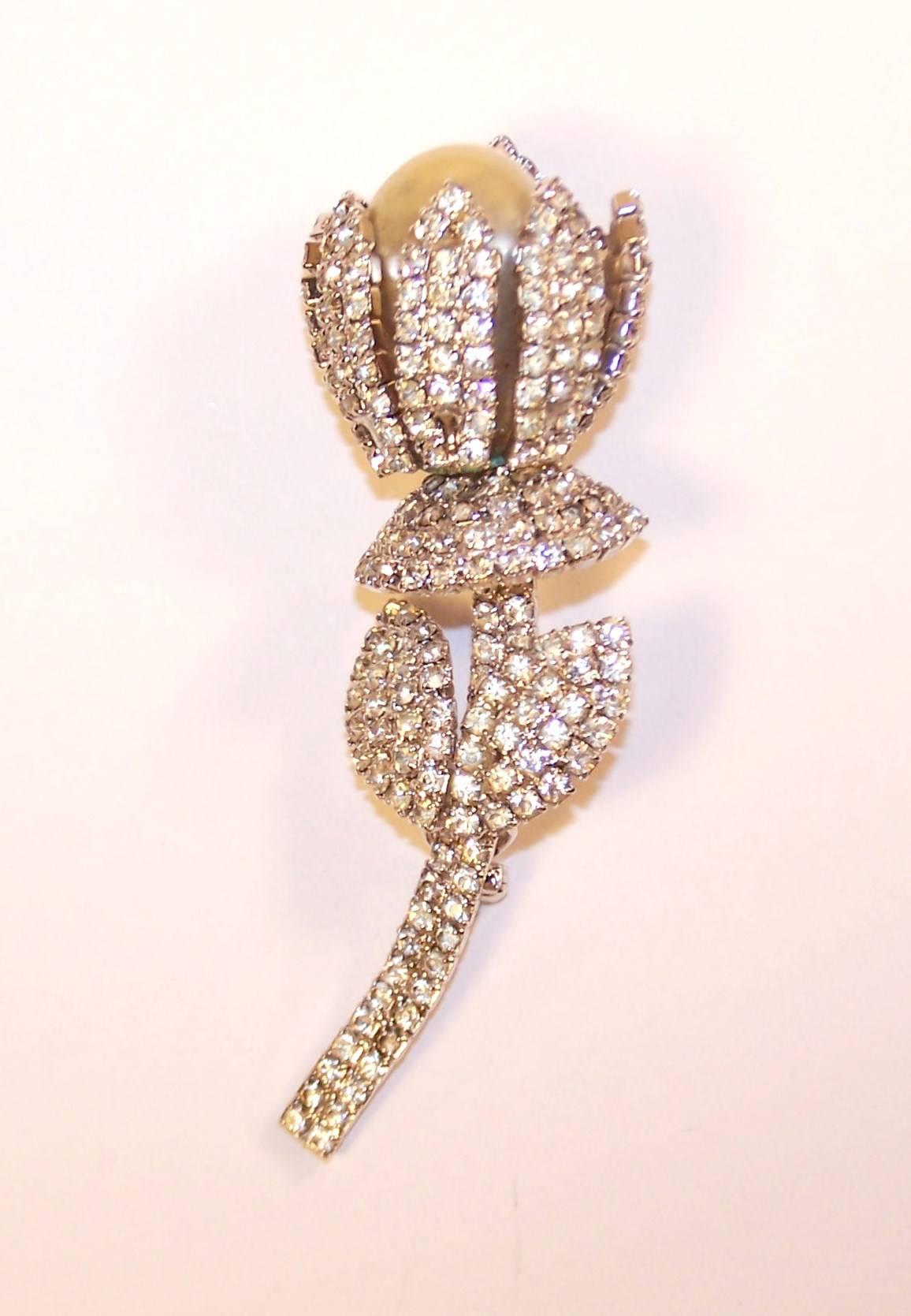 Sprout a rhinestone flower from your shoulder with this lovely brooch by Vendome, the high end mark for the Coro jewelry family.  The silver tone metal base is enhanced with faceted rhinestone sparklers that serve as a crown to a large baroque