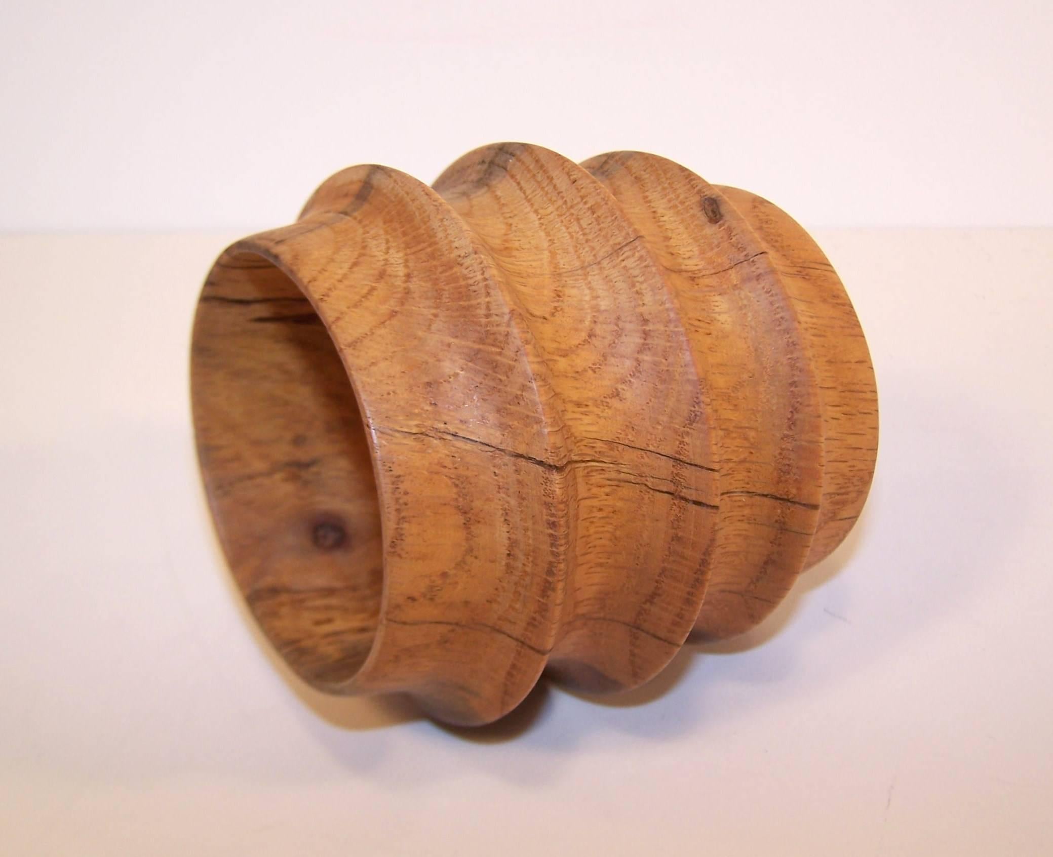 This beautiful wood bracelet is the perfect combination of both a primitive and a sculptural aesthetic.  The extra wide form is shaped and ribbed to provide a ringed effect.  All the natural elements of the wood are on display including grain, knots