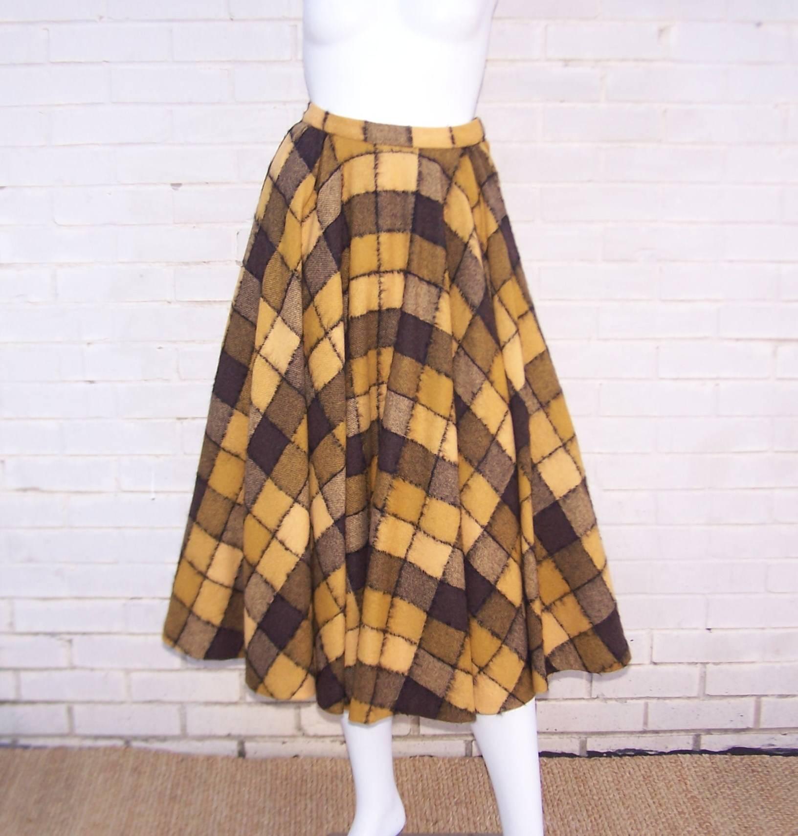 This voluminous checkered golden yellow, brown and black wool skirt by Herbert Labandter  is the perfect 1950's circle silhouette.  The skirt hooks and zips on one side with a generous side pocket on the other side.  The checkerboard print is