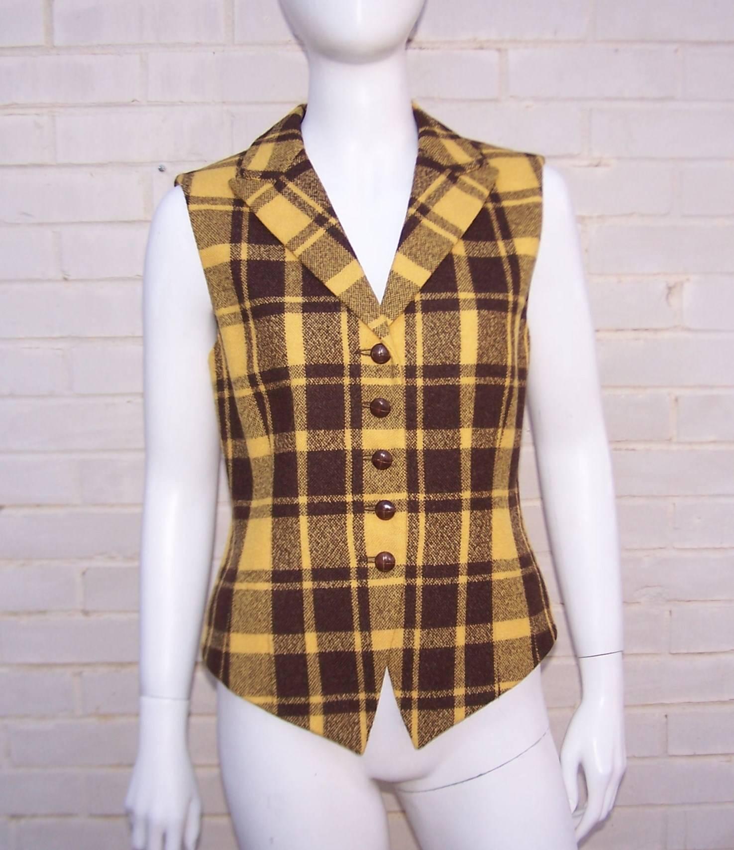 This 1980's Mondi vest is reminiscent of the menswear styles of the late 1800's.  The nipped waist, v-front and vent back give it a decidedly feminine touch.  A tweedy golden yellow and chocolate brown wool plaid mixes well with winter woolens and