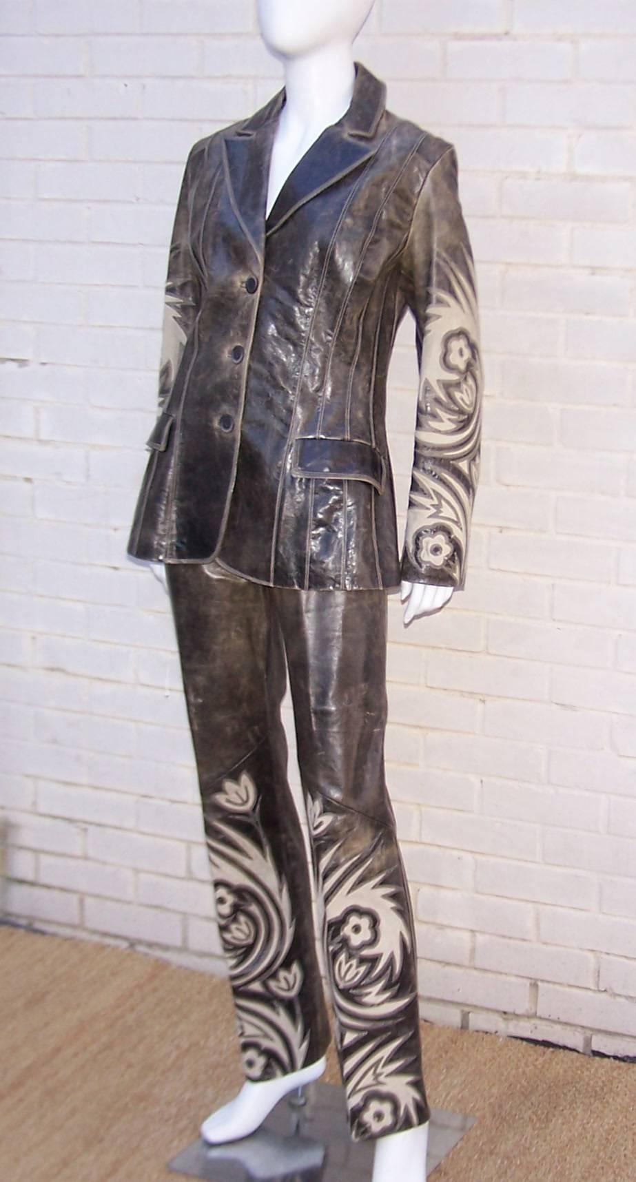 They'll see you coming and going in this detailed Roberto Cavalli leather suit with jean styling and distressing by design.  The pliable leather is a grayish tone with lighter brown distressing.  Both pieces are decorated with stitched layered