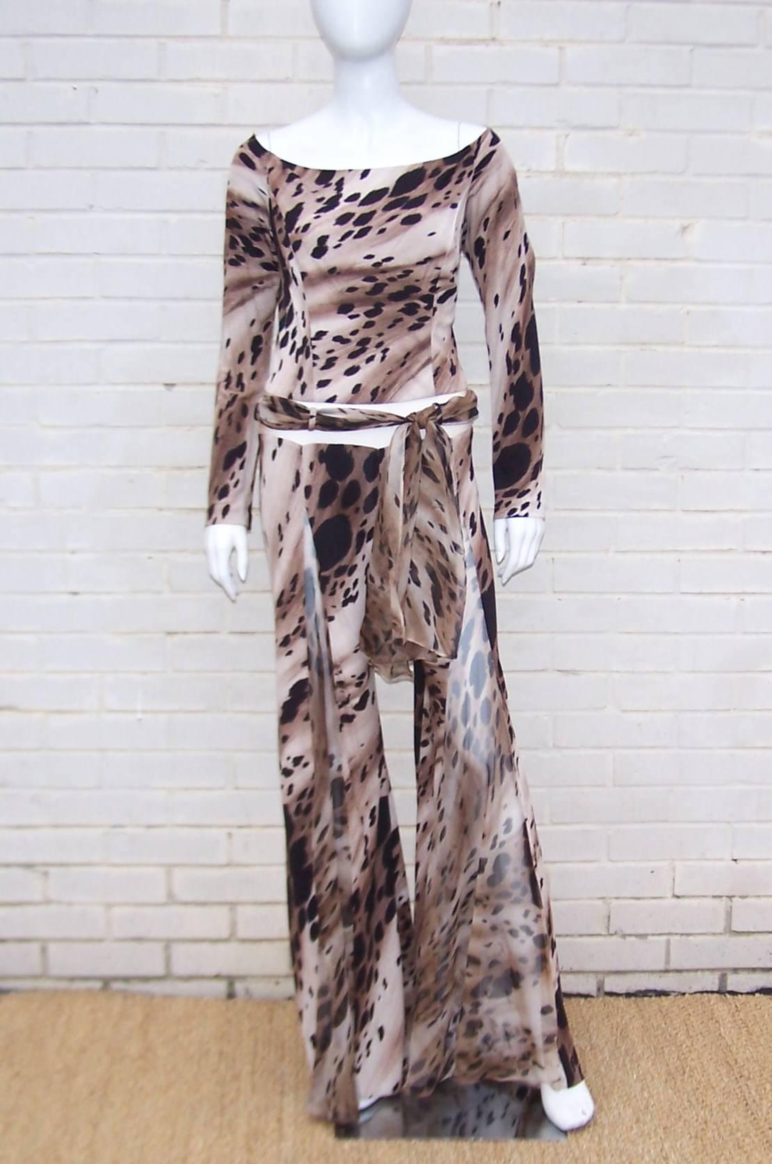 Channel your inner wild child with this outrageous 1970's inspired animal print catsuit from Jiki of Monte Carlo.  The design incorporates peek-a-boo effects by inserting nude netting just below the waist and coordinating sheer animal print chiffon