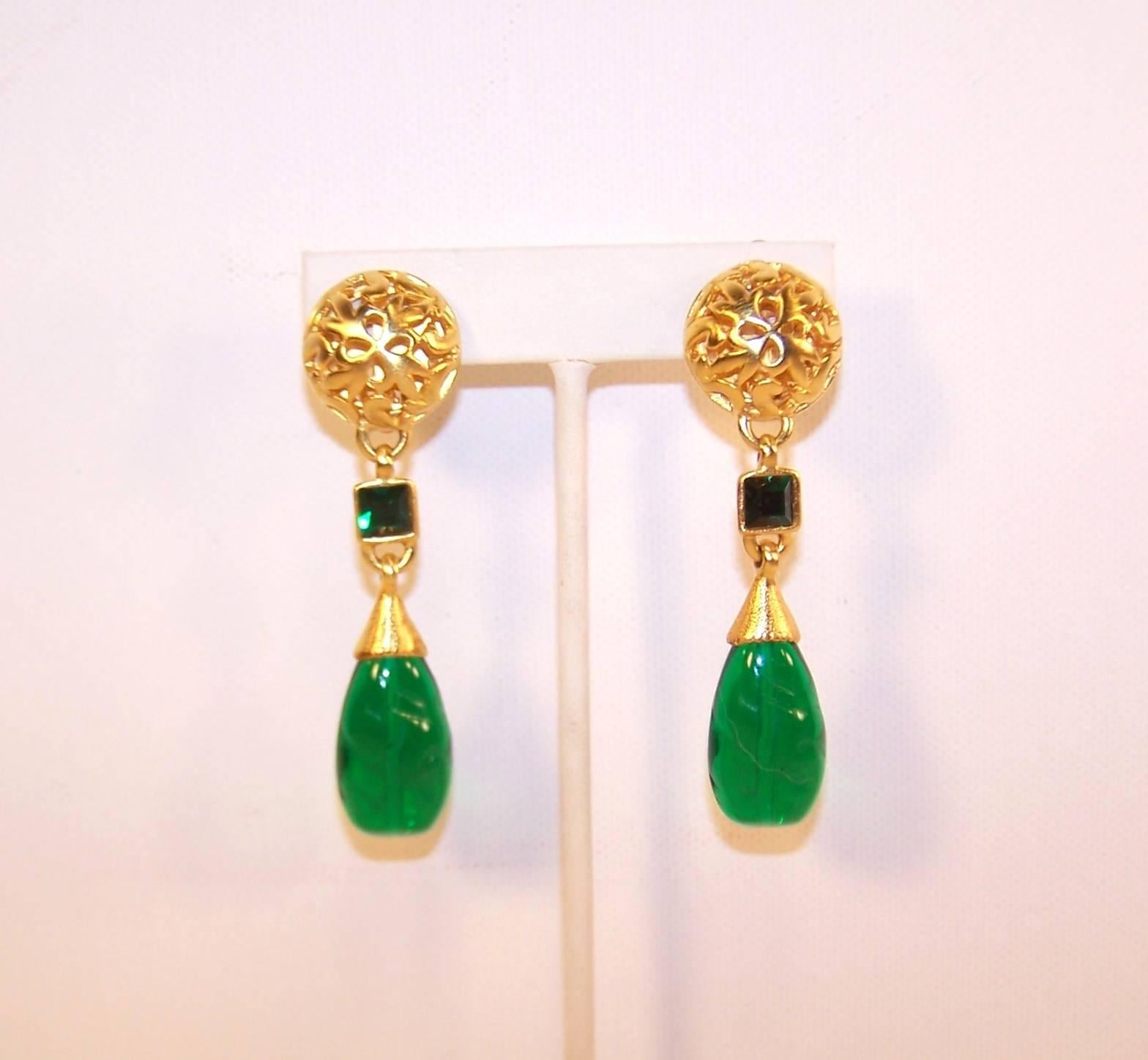 Green and gold...a stunning combination!  This lovely dangle clip on earring by Issac Manevitz for his jewelry line, Ben-Amun, is an excellent example of sophisticated style.  The filigreed brushed gold tone base suspends a two part dangle of a