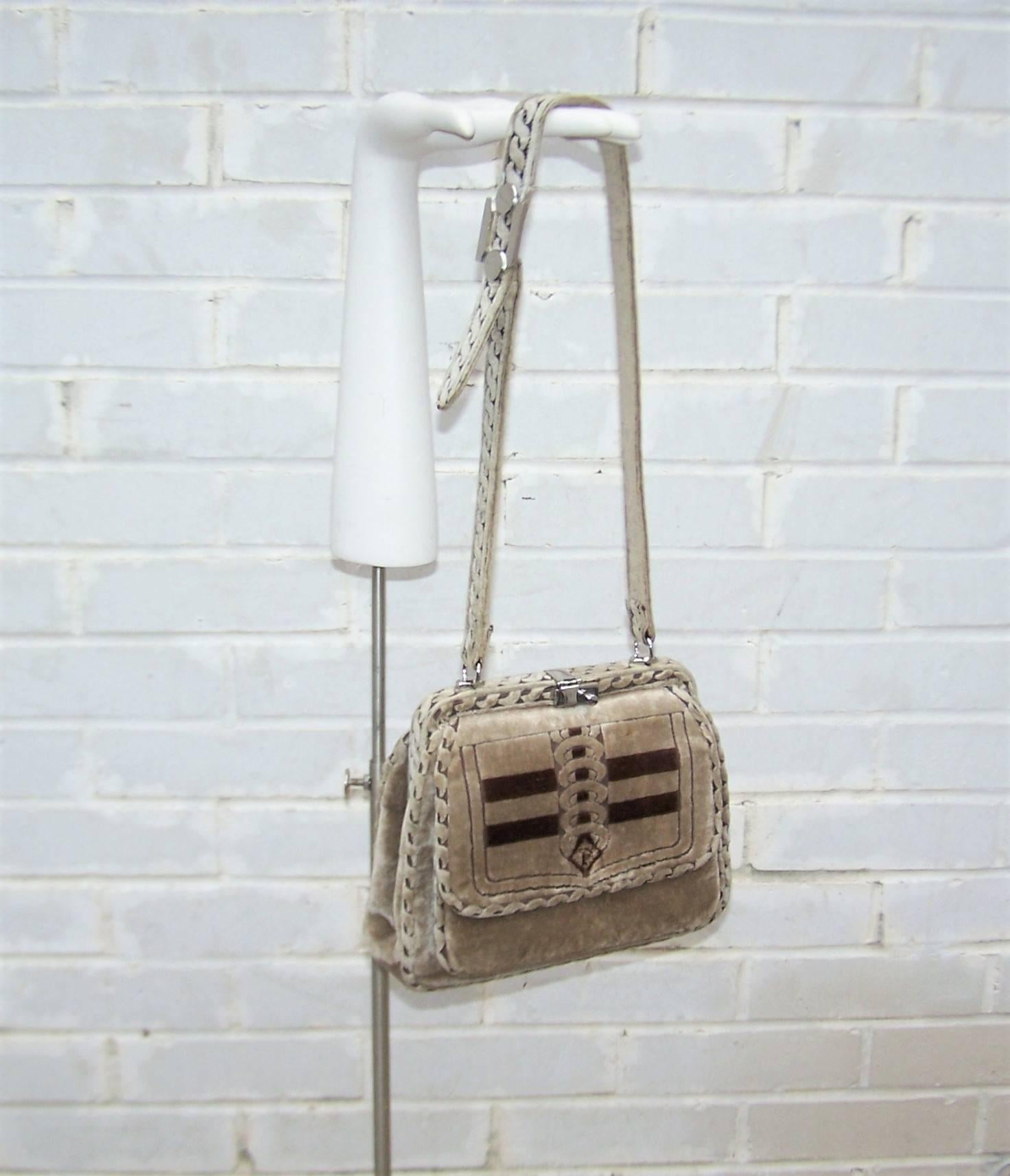 This 1960's handbag is a tactile delight brought to you by the Biagiotti family of Florence, Italy, doing business as 'Giotti'.  The plush taupe velvet is highlighted by light brown trompe l'oeil graphics mimicking braid with an intricate design at