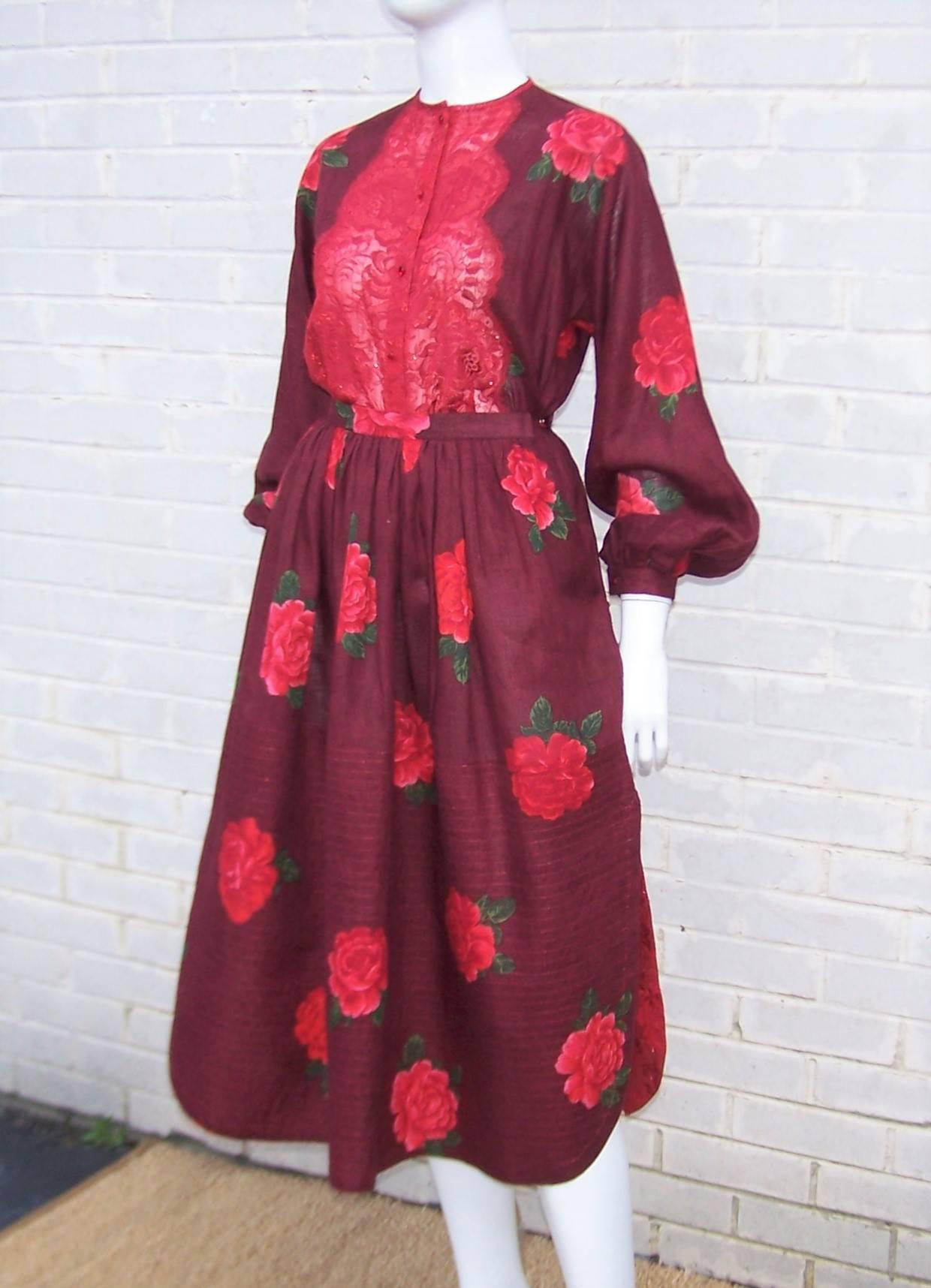 Wearing this 1970's Geoffrey Beene two piece ensemble is akin to walking in a rose garden.  The gorgeous burgundy linen fabric is printed with red roses highlighted with pink and green.  The peasant style top closes at the front with ruby red