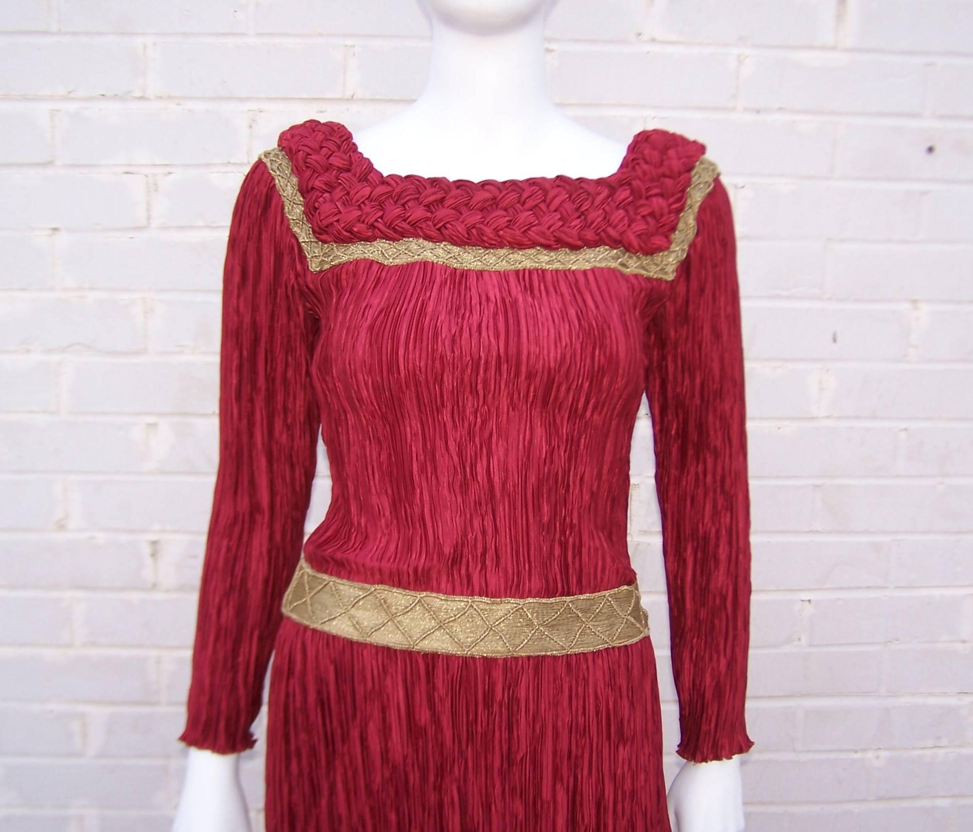 This gorgeous burgundy red dress by Mary McFadden conjures up images of romanticism and King Arthur's court.  Ms. McFadden's signature micro pleated fabric is a nod to the feminine designs of Mario Fortuny and is sure to show off your best assets. 