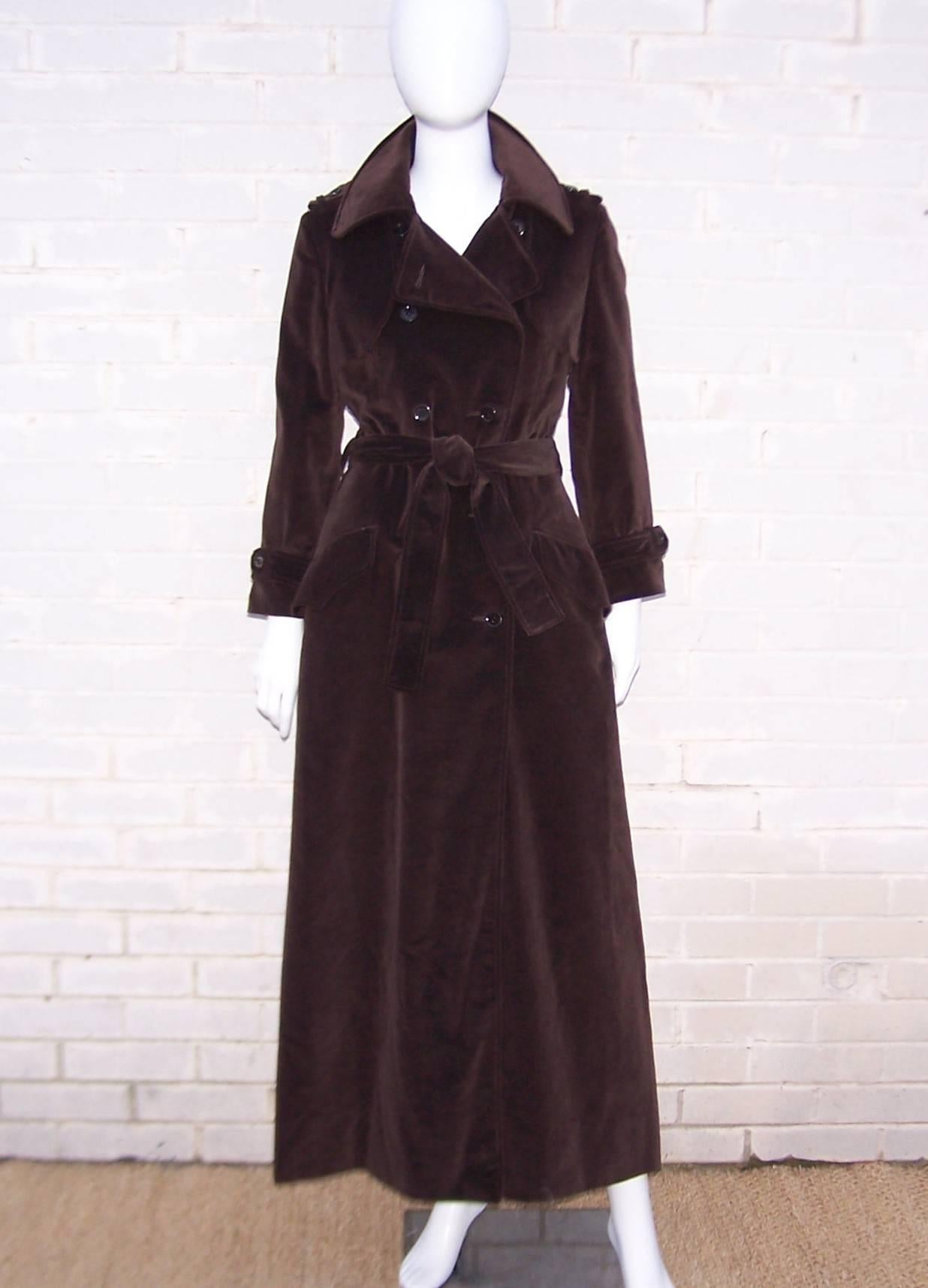 Don this 1970's Calvin Klein chocolate brown trench coat and step out looking like a Bond girl.  The classic trench coat details and maxi length with a 30" high back slit are a perfect combination of drama and practicality.  The coat buttons at