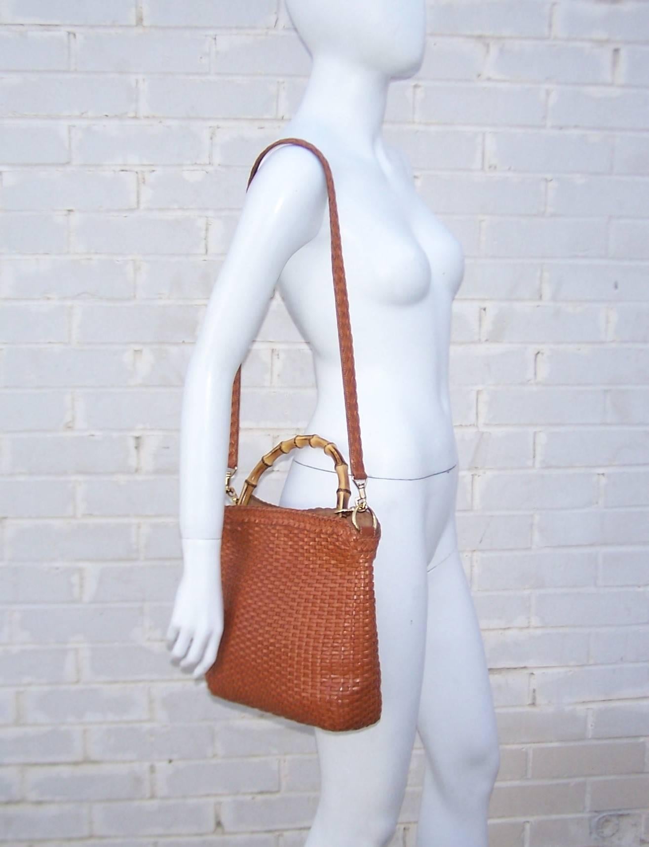 This versatile 'go to' handbag from Gucci has classic bells and whistles with a modern approach to functionality.  The cognac leather body is woven into a casual design which promises to age beautifully while the iconic Gucci bamboo top handle is a