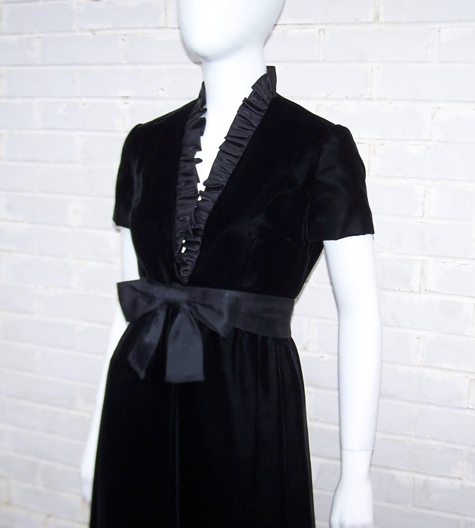 Both simple and dramatic at the same time, this c.1970 black velvet dress from Saks Fifth Avenue's Park Avenue Room has a ruffled plunging neckline perfect for strategically revealing decolletage.  It zips and hooks at the back with a modified