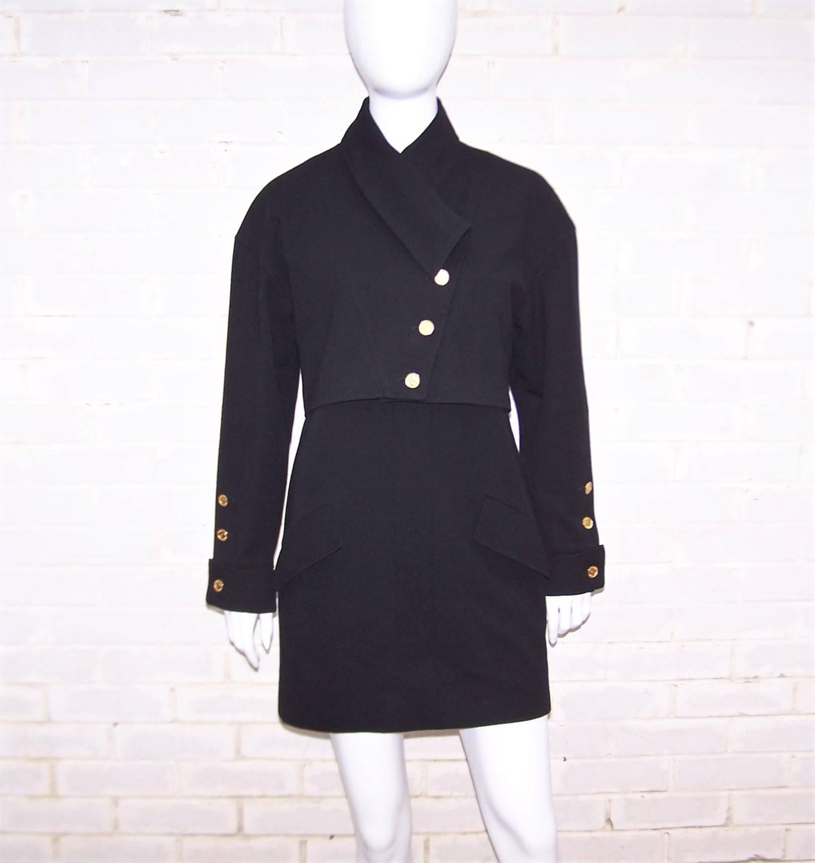 This 1980's Chanel Boutique black wool knit dress and jacket ensemble is reminiscent of 1960's mod shift jumper dresses with the added bonus of an adorable military style cropped jacket.  The sleeveless dress zips and hooks at the back with a boxy