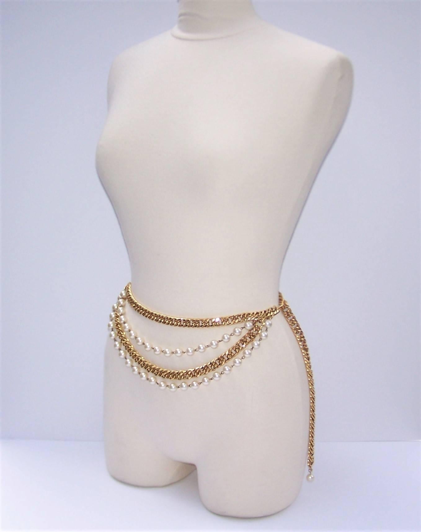 This high quality gold chain belt with pearl embellishment has a classic Chanel look without the price tag.  The heavy gold link chain features a front swag of two pearl strands and one additional gold link strand.  It is designed to hook at the