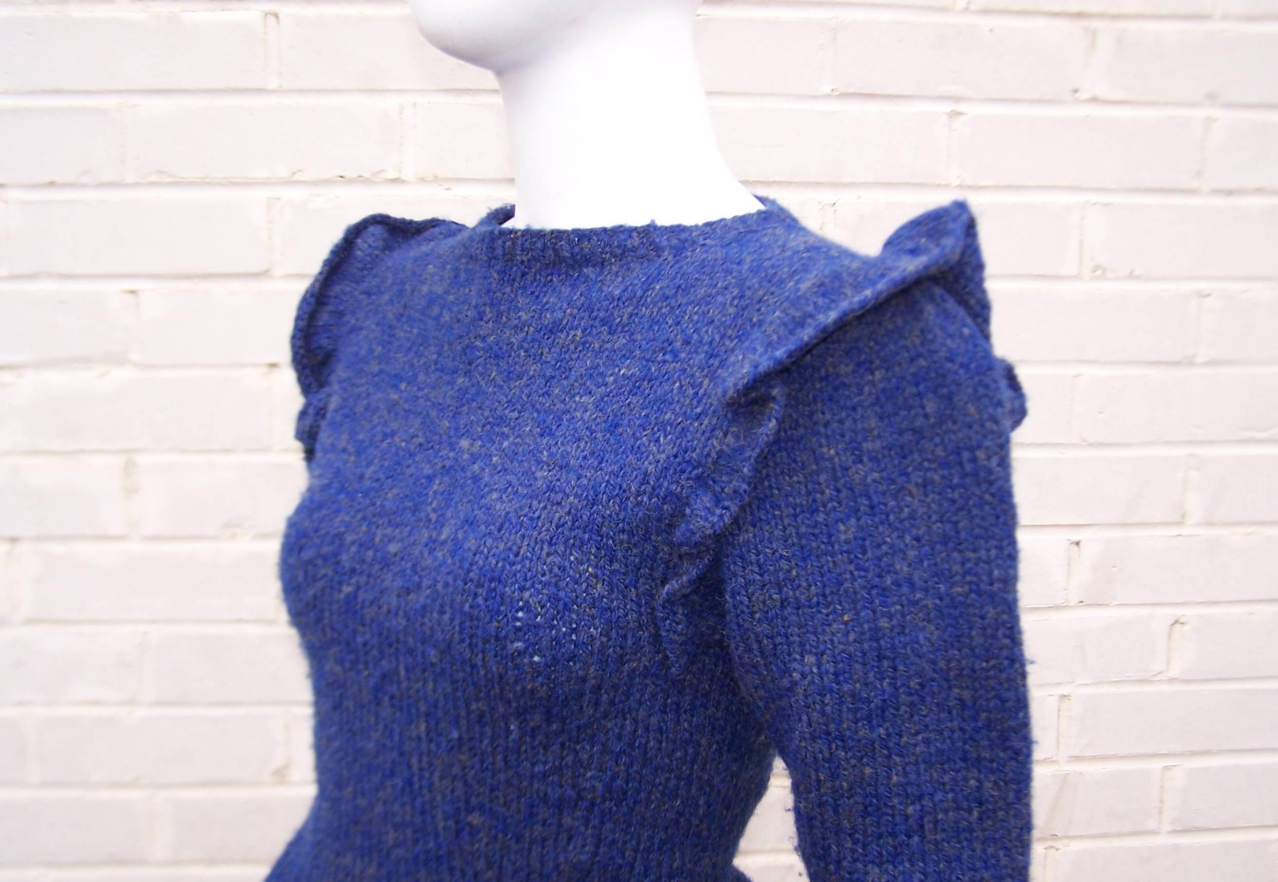Love the details on this C.1980 sweater from Perry Ellis.  The lapis blue wool is accented with gray flecks to create a vibrant color combination perfect for adding color to your woolens.  The pullover style features a modified ballerina neckline