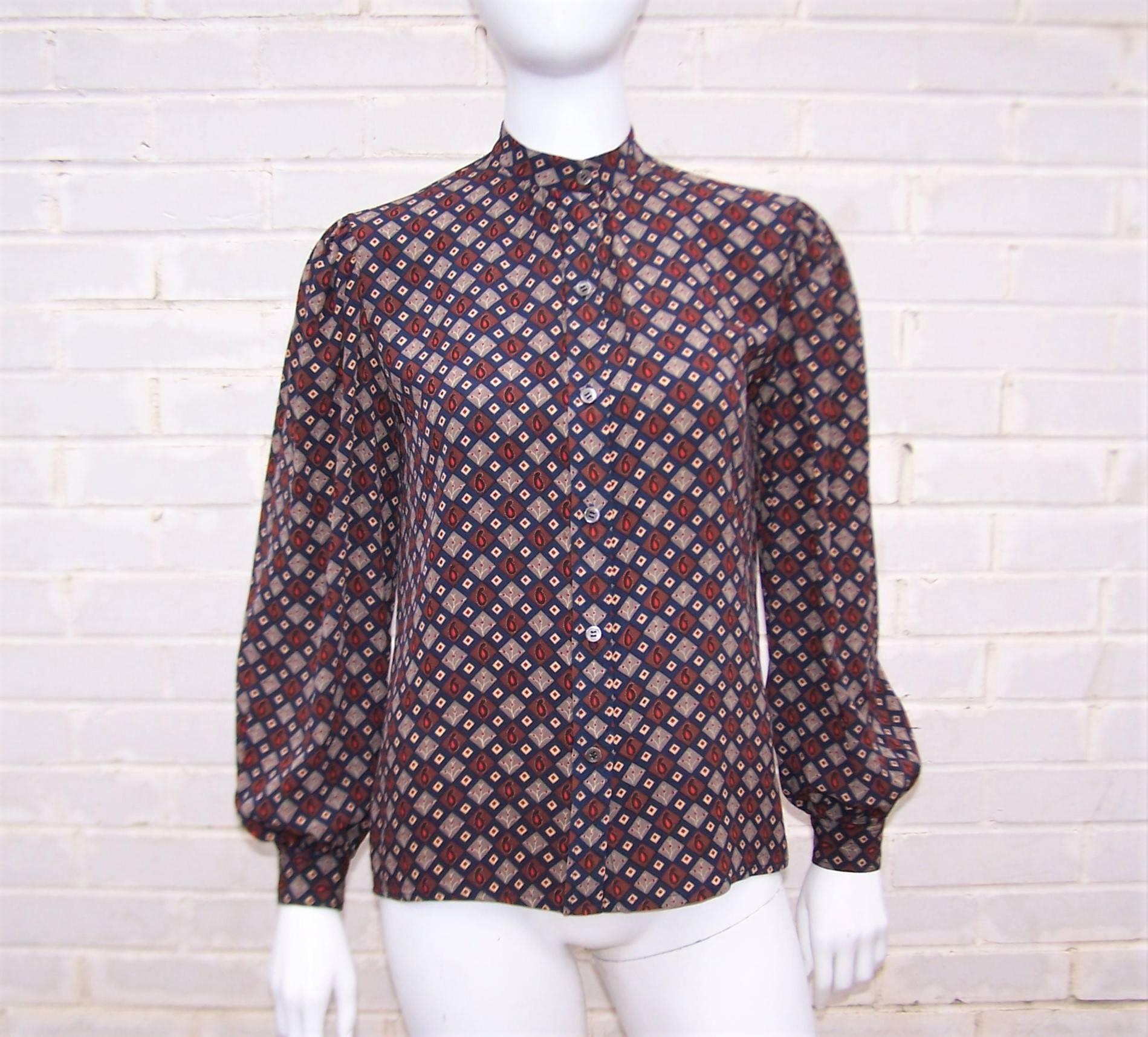 The lovely details on this Christian Dior silk blouse make it a perfect foil for everything from high waist trousers to jeans.  The soft gathering at the button front and back of the mandarin style collar along with the gathering at the top of the