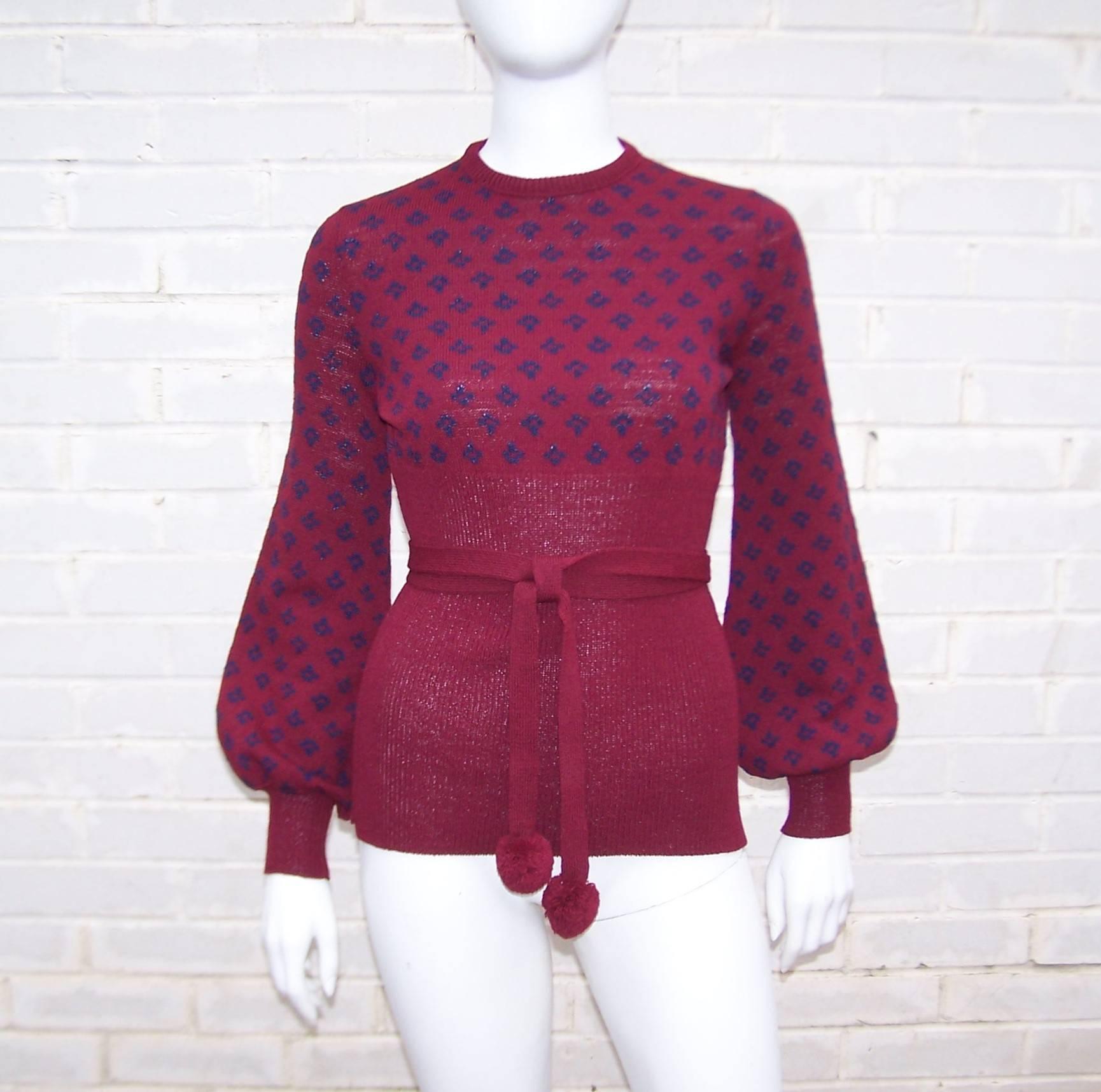 This 1970's Saks Fifth Avenue knitwear top is reminiscent of the sexy skimpy sweaters worn by Jane Fonda's character in Klute.  It zips at the back with a form fitted ribbed empire waistline and skinny shoulders and sleeves that puddle as they near