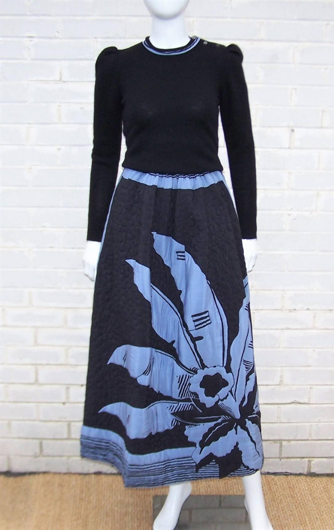 Michaele Vollbracht's talent as a graphic artist is evident in the pop art design of this maxi quilted skirt and cashmere sweater ensemble.  The black silk skirt contrasts with the periwinkle blue tropical floral design which is bordered by stripes.