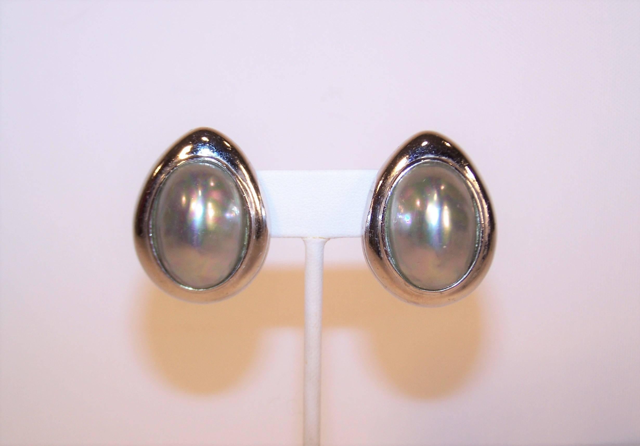 Who cares about the goose that laid the golden egg when you have Ciner's glamorous silver version!  These silver tone earrings are the perfect frame for an oval dome shaped silvery faux pearl with subtle pink colors.  The clip on backs are