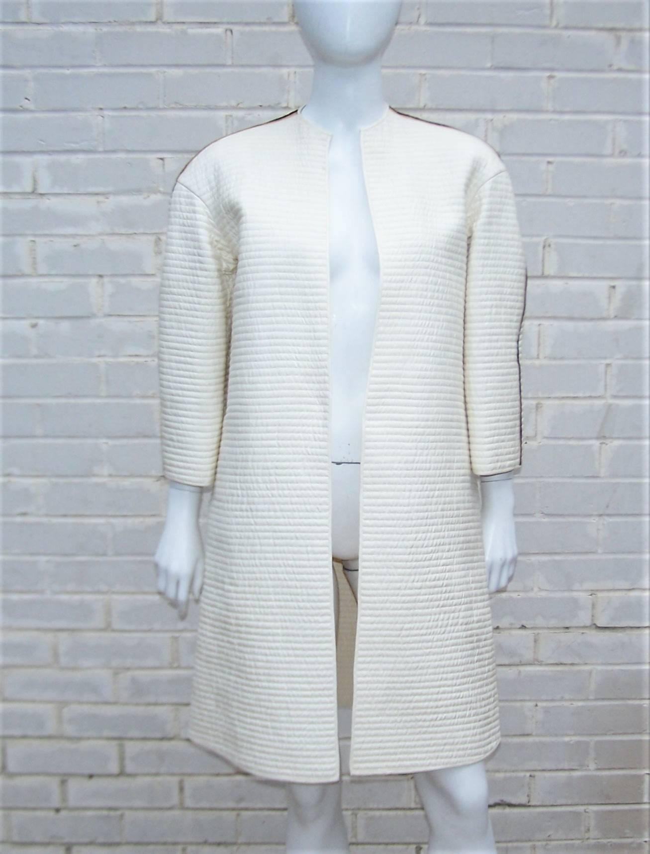 Have an exotic evening with this gorgeous Mary McFadden quilted ivory white coat with black and gold embroidered pinstripes across the shoulder and sleeves.  The stylized shape works well as a topper over palazzo or cigarette pants.  It has an open