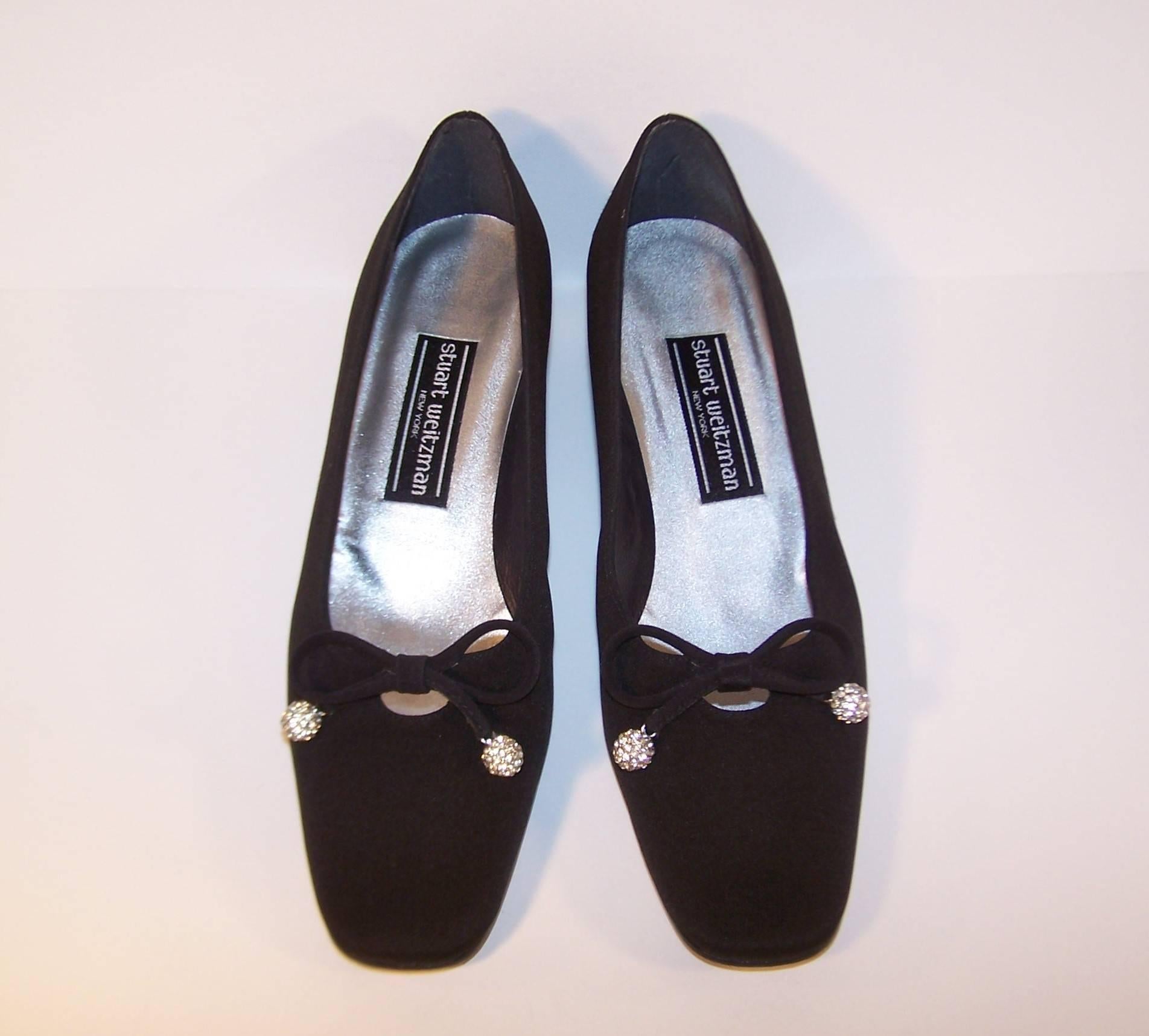 The high heeled evening shoe has a well deserved place in every wardrobe but these classic evening slip-ons by Stuart Weitzman will be your favorite 'go to' option for comfort without sacrificing style.  The black faille fabric embellished with a