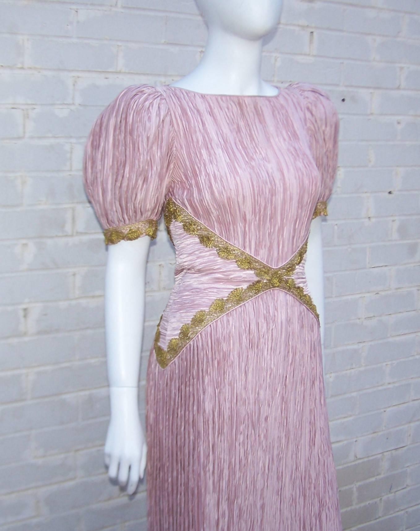This lovely dress incorporates Mary McFadden's signature exotic style with ultra feminine details to create a modern goddess silhouette perfect for many occasions.  The pale rose pink micro pleated fabric is a nod to the feminine designs of Mario