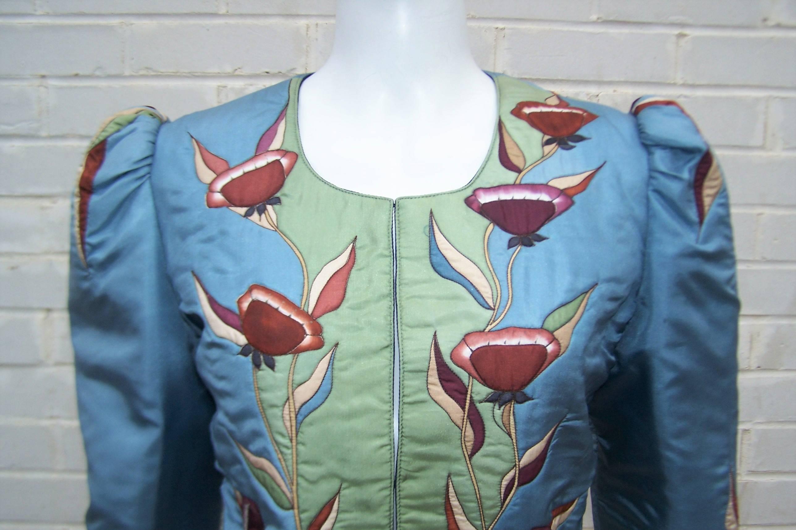 Wear a lovely art nouveau floral bouquet!  This Osnat hand painted silk jacket is truly wearable art with a 1970's bohemian nod to art nouveau style.  The silk is painted, stitched and quilted in sky blue and sage green, with various shades of