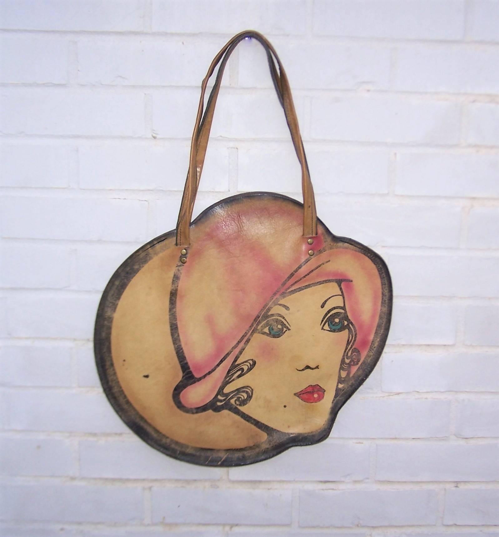 Oh you pretty things!  This bohemian handbag looks like it would fit right into the mod scene of swinging 1960's London boutiques such as Biba.  The hand painted front side of the leather silhouette pictures a lovely flapper girl in soft shades of