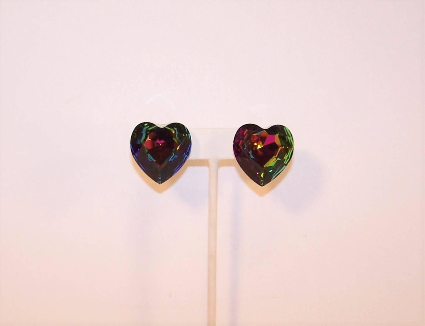 Magical and mesmerizing!  These dark aurora borealis faceted crystal clip on earrings are heart shaped and reflect the loveliest shades of green, pink and blue.  Backed with clear resin and comfortable enough for all day wear.  Excellent