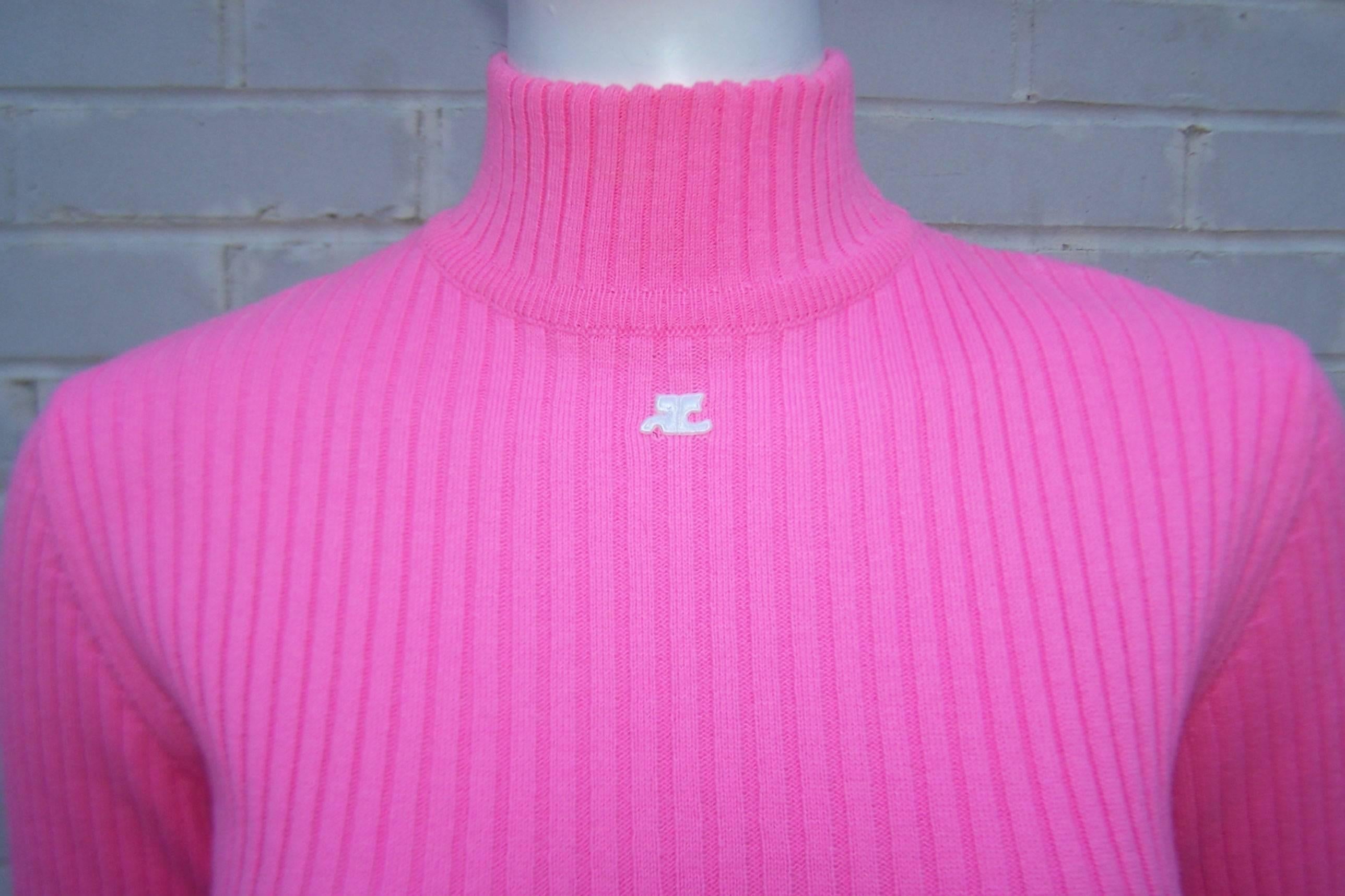 This current Courreges mock turtleneck sweater has a mod 1960's vibe with a vibrant color pop.  The wool blend is perfect for warm weather seasons and the ribbed design is both relaxed and body conscious.  The hot pink color and mod white Courreges