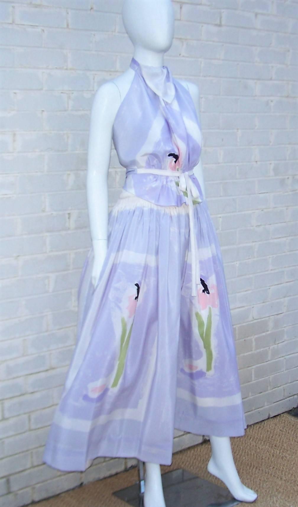 Michaele Vollbracht's talent as a graphic artist is evident in the abstract floral design of the silk fabric used in this 1970's two piece halter dress with coordinating wrap scarf.  The silk fabric is a light lilac purple (though it appears a shade