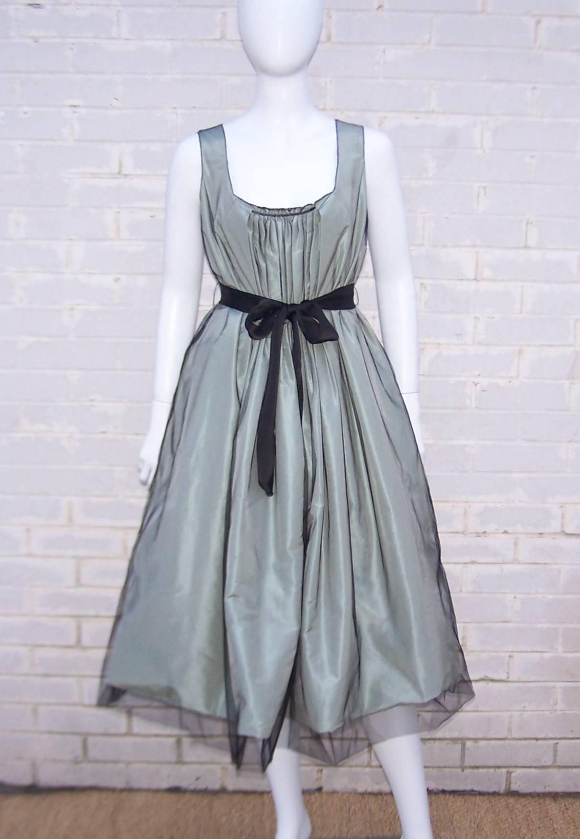 Oh the luxury and opulence of an Oscar de la Renta dress!  This modern rendition of a ballerina silhouette has old school romanticism and stylish construction in one package.  The sage green silk taffeta dress zips and hooks at the side with