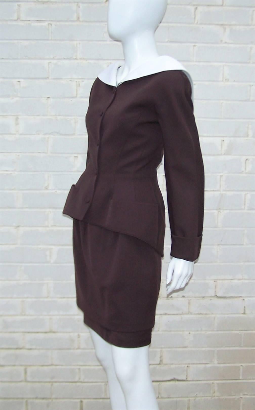 Attention to vintage style details with a unique futuristic silhouette are all hallmarks of French designer, Thierry Mugler.  This two piece suit is cut from a chocolate brown wool gabardine and accented with a white cotton pique portrait collar. 