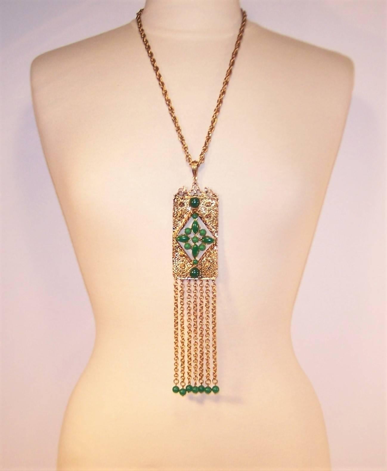 This 1970's etruscan revival medallion necklace makes a statement and compliments bohemian styles.  The rectangular 4" x 1.88" gold tone metal medallion has a brutalist finish that on close inspection resembles spider webs and abstract