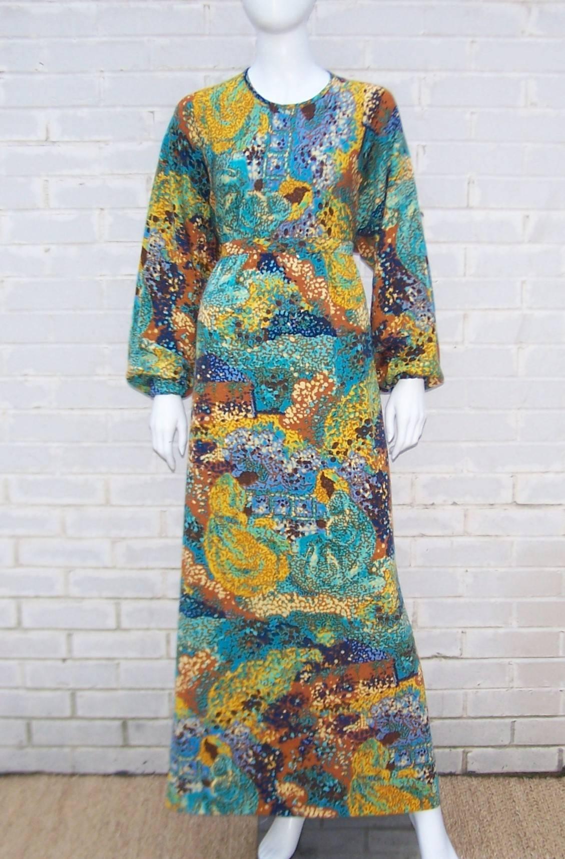 Goldworm was a New York based company that produced stylish knitwear incorporating Italian fabrics and designs.  This 1970's maxi dress is a vibrant abstract impressionist print with a range of colors including aqua, greens, blues, browns and