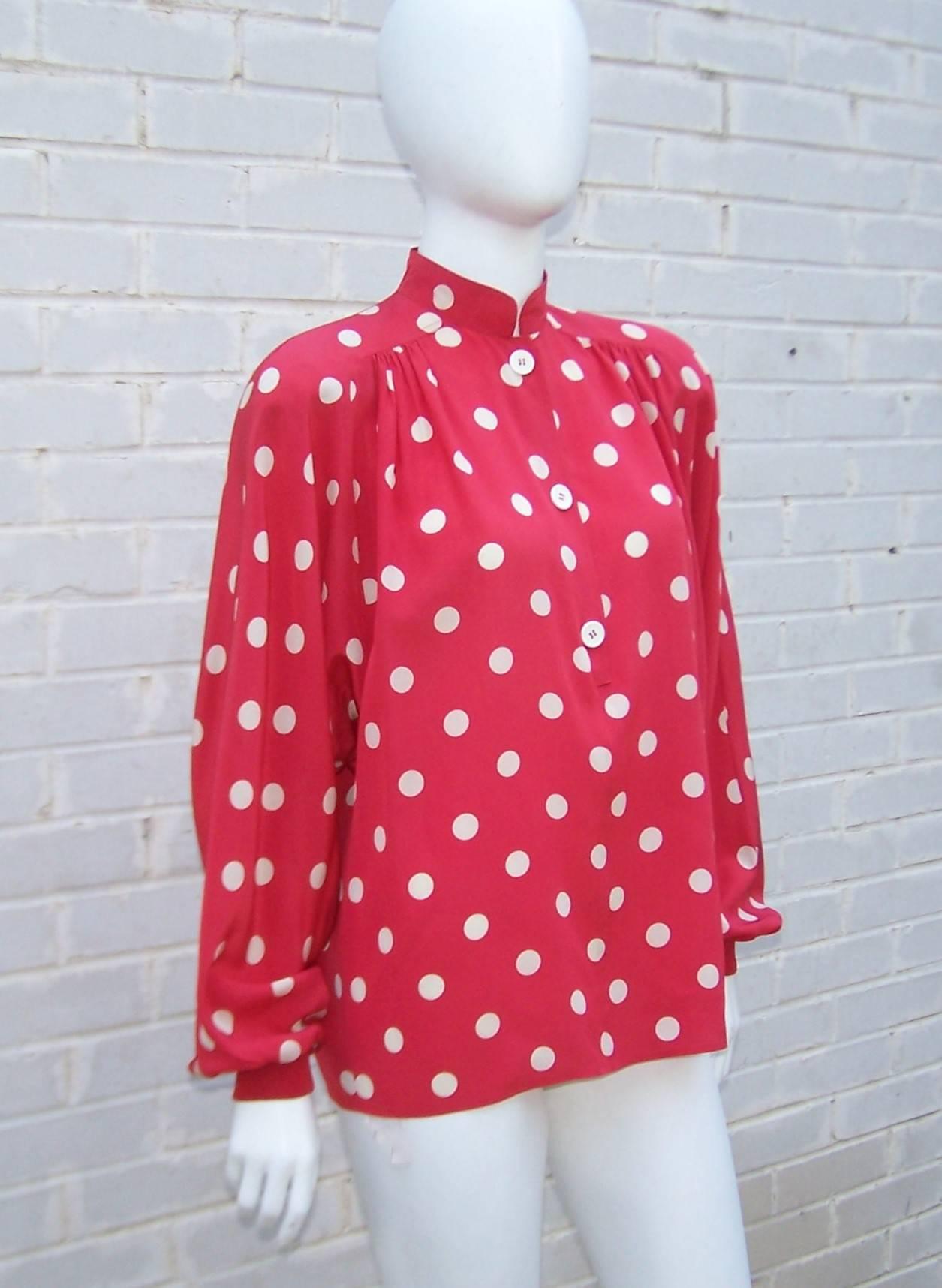 Polka dots always bring a smile.  This Valentino 'Miss V' silk red and white blouse can be a casual topper or paired with a suit for a polished look.  It partially buttons at the front with a mandarin collar, shoulder pads and ribbed knit cuffs. 