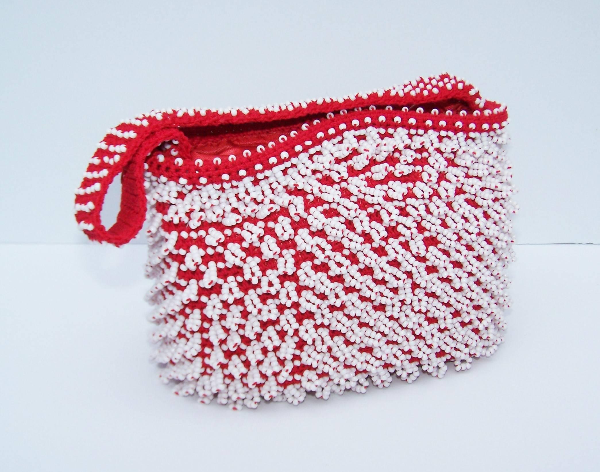 Boho meets mod in this fun little 1960's handbag by Walborg.  Hilde Walborg founded her company in the 1940's and was always in search of the best handmade beading for her designs.  This red knit bag was made in Japan with looped white beading which