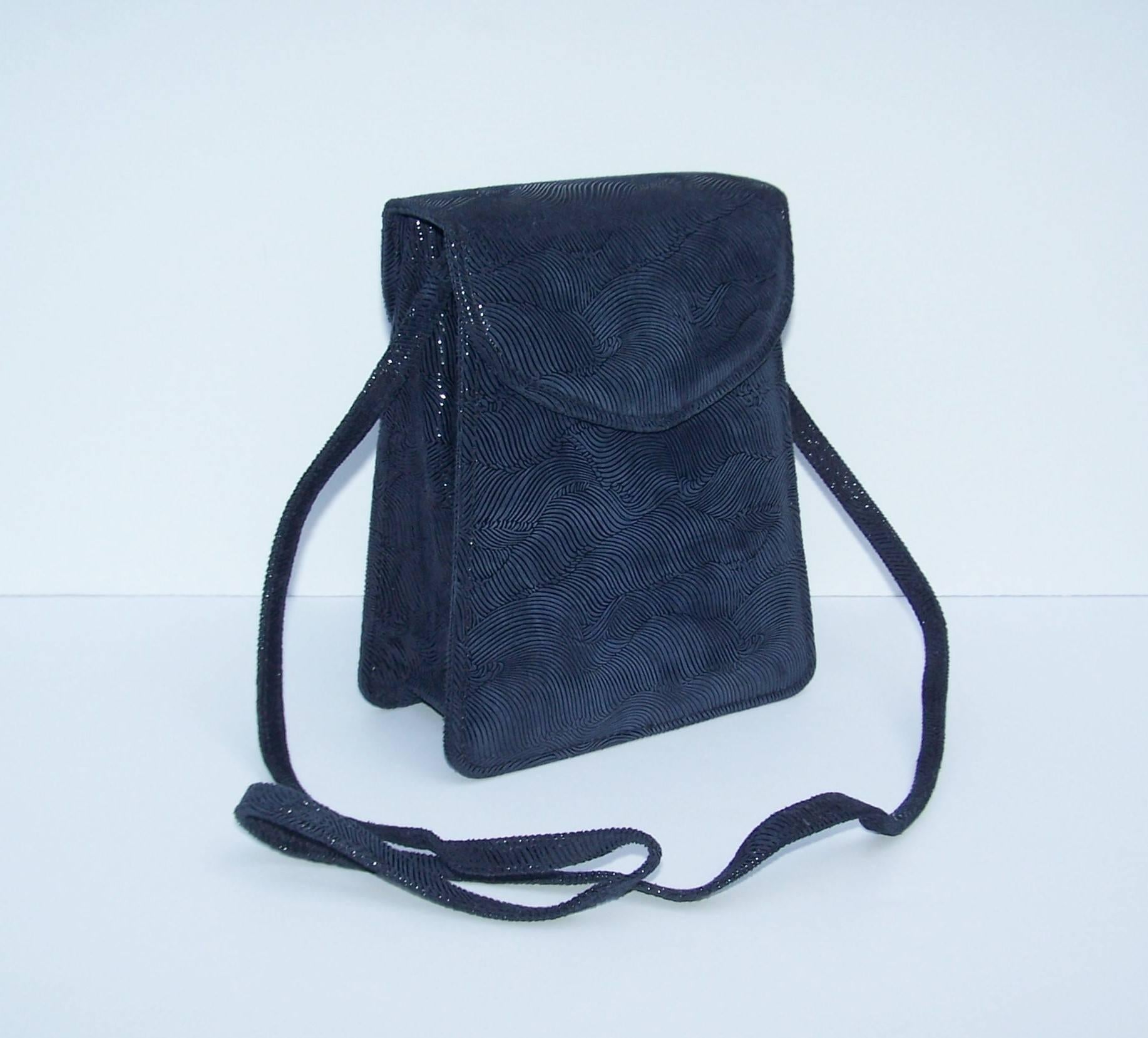 Michelle & Michael LaLonde create wearable art handbags featuring sophisticated design and unique details.  This navy blue suede leather handbag is silk screen printed to create a design that catches the light and mimics a wave pattern.  The