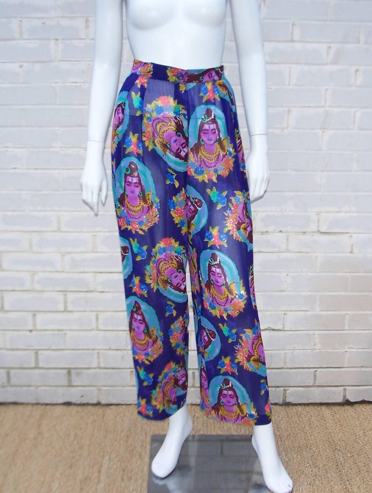 These goddess print pants by Emanuel Ungaro are the perfect foil for the warm weather season or a tropical excursion.  The lightweight gauzy fabric features a vibrant print of blues, purples, aqua, yellow, green and orangey red.  The star of the
