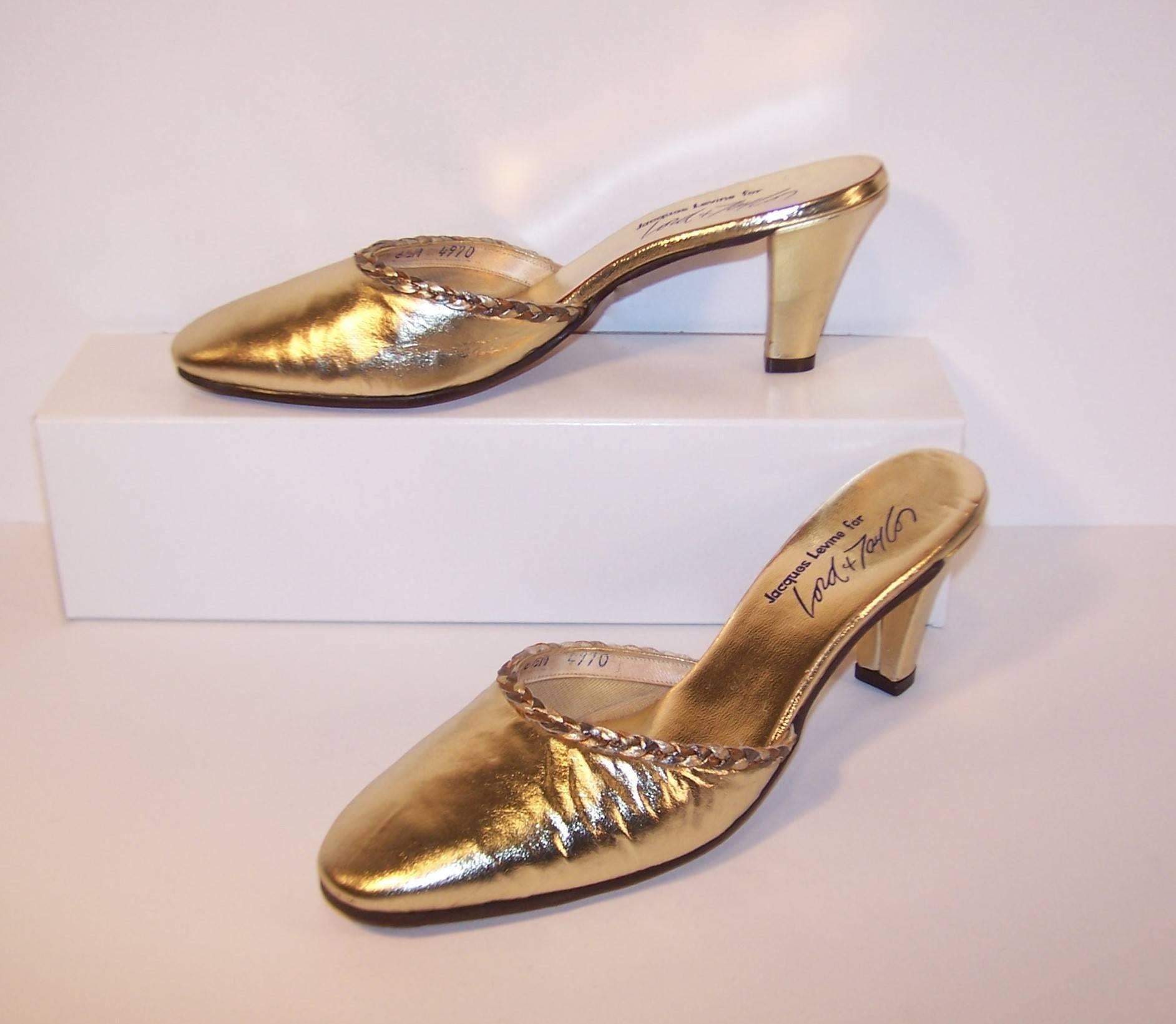Jacques Levine is best known for producing stylish slippers that are the perfect accessory for glamorous hostess wear.  These gold leather mules can perform double duty as slippers and evening shoes.  The simple style is embellished with gold and
