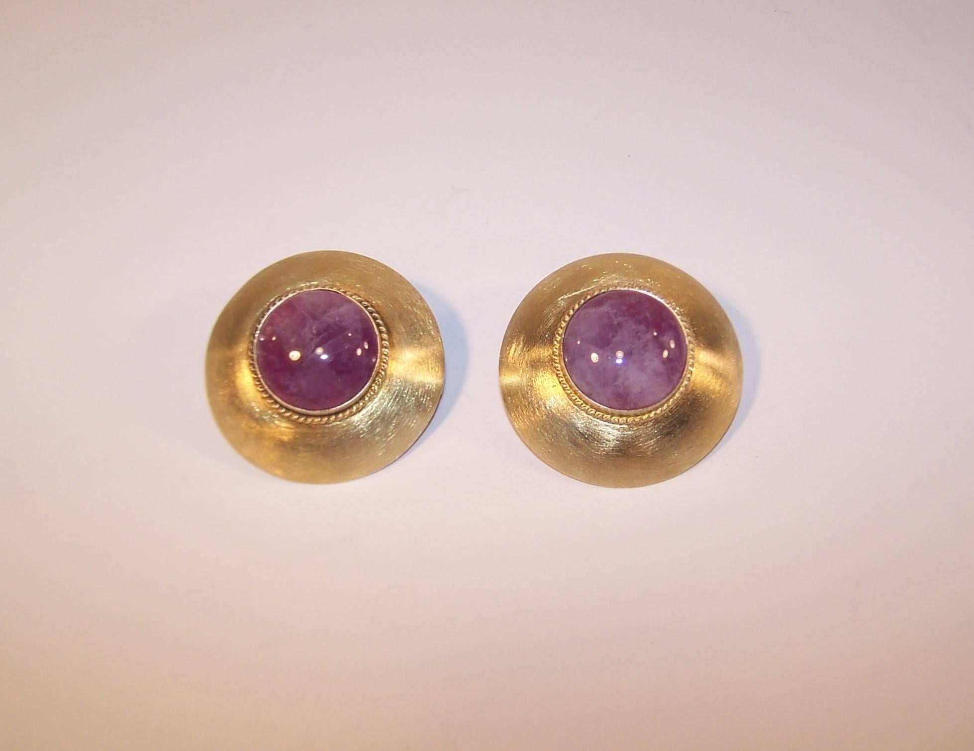 Harlene Korey's hand constructed creations for Kalibre combine a sophisticated style with a casual elegance.  These sterling silver vermeil earrings have a brushed surface with a braided detail framing a domed amethyst quartz.  The combination of