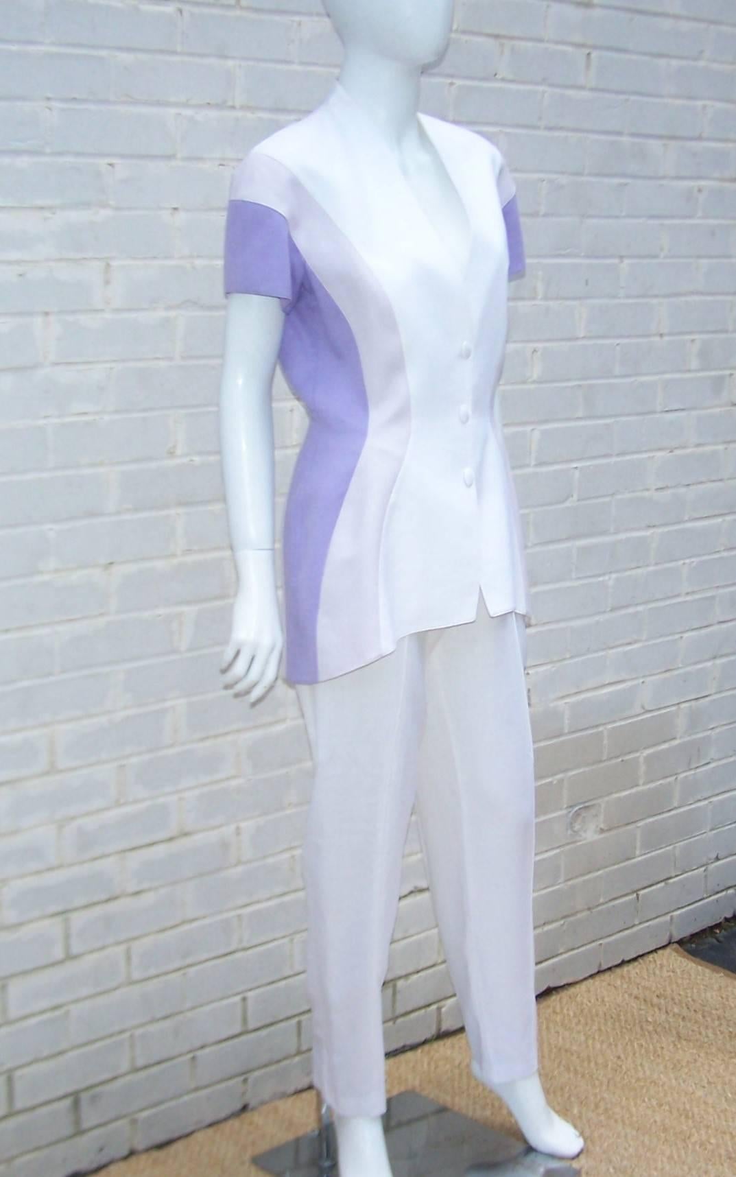 As with many of Thierry Mugler's designs, this 1980's linen suit is an inspired combination of a futuristic style with a nod to the strong silhouettes of the 1940's.  The short sleeved jacket has an elongated wasp waist shape with soft shoulder