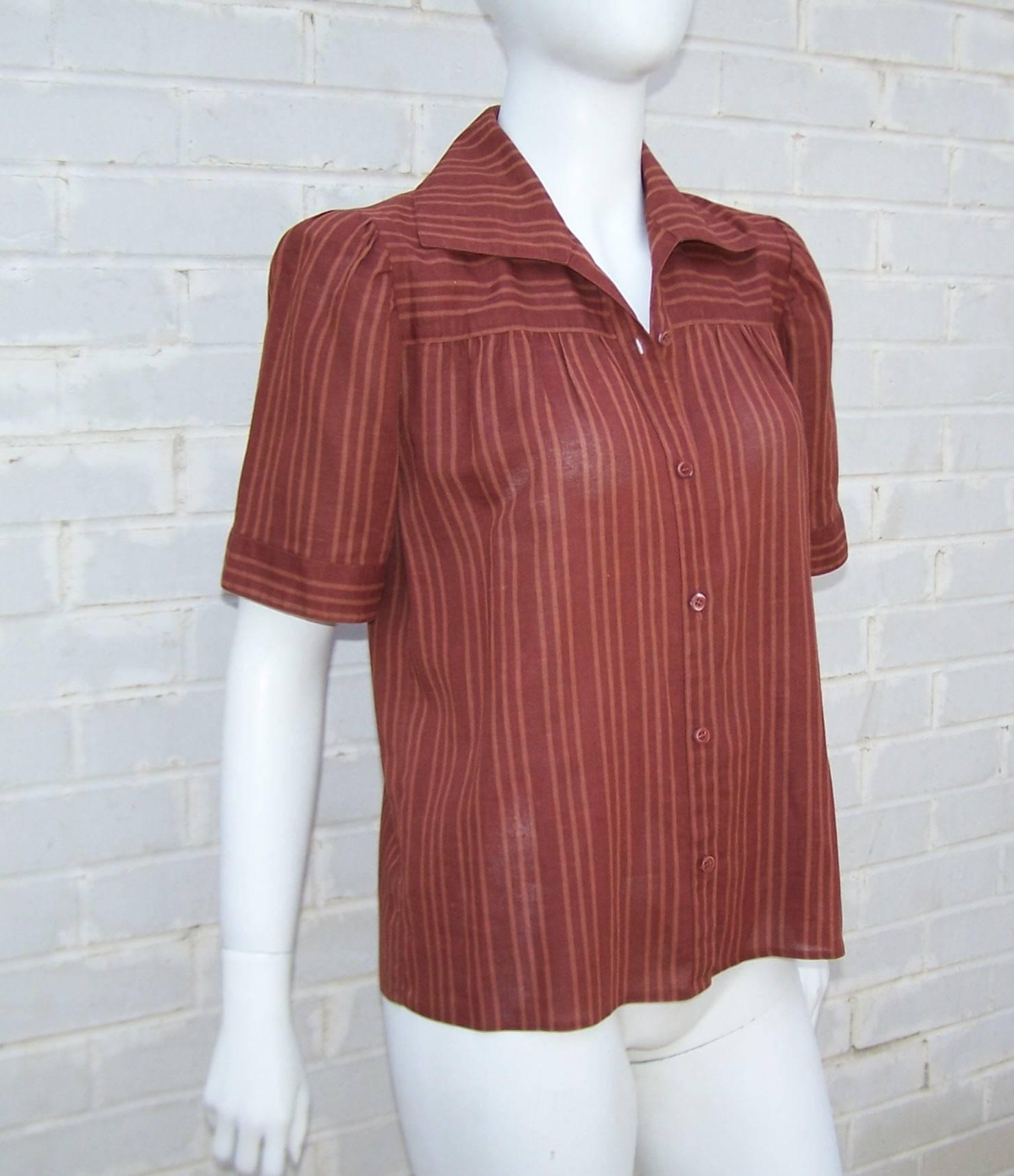 An airy and effortless 1970's linen top by Yves Saint Laurent which is perfect for the warm days of Summer and the mild days of Fall.  The reddish brown striped fabric is expertly cut to provide horizontal stripes across the shoulder with vertical