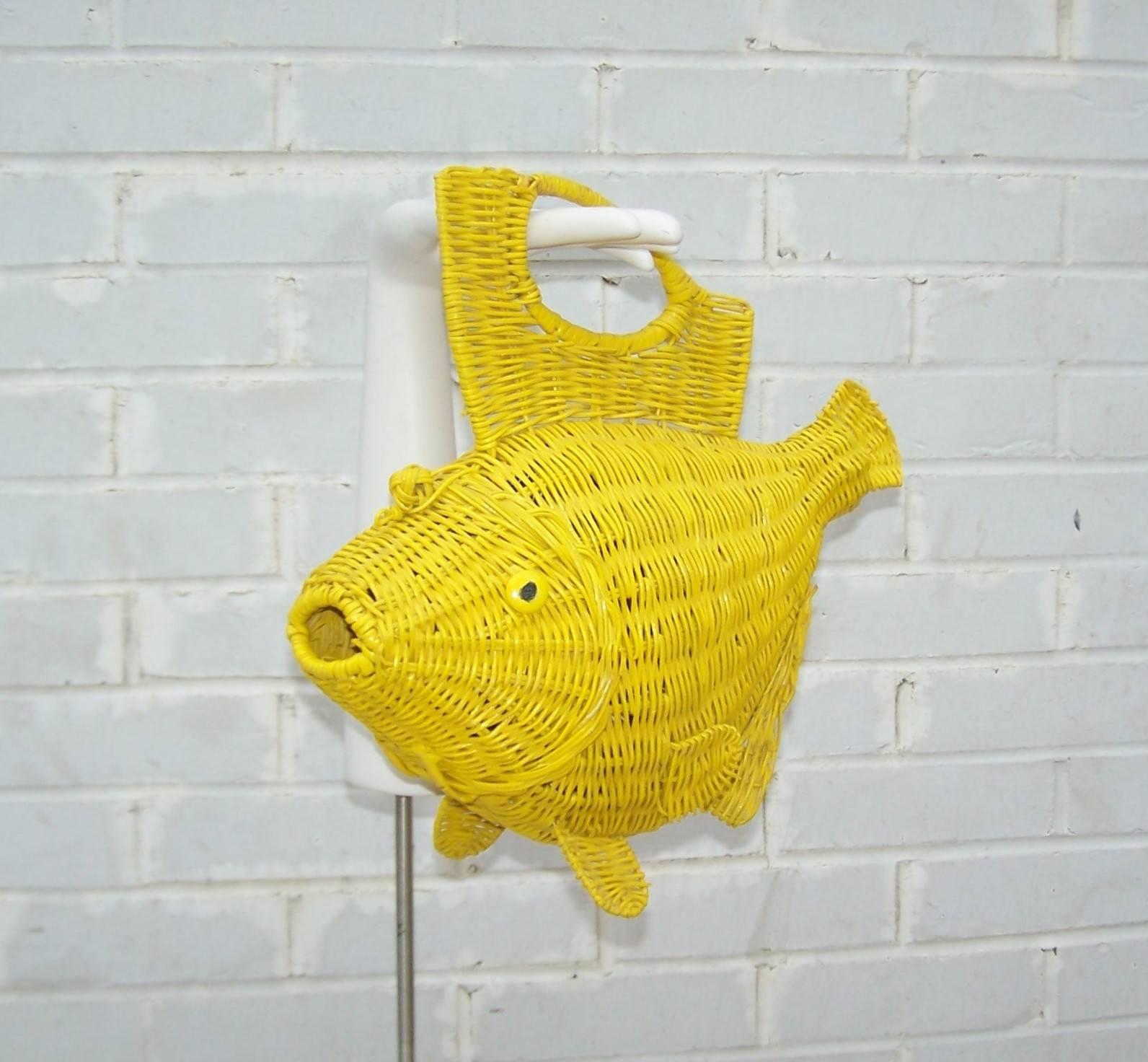 Personality plus!  This 1950's novelty handbag is a great conversation piece and functional to boot.  The canary yellow wicker fish frame opens at the head with an elasticized frog style closure and reveals a roomy interior suitable for modern