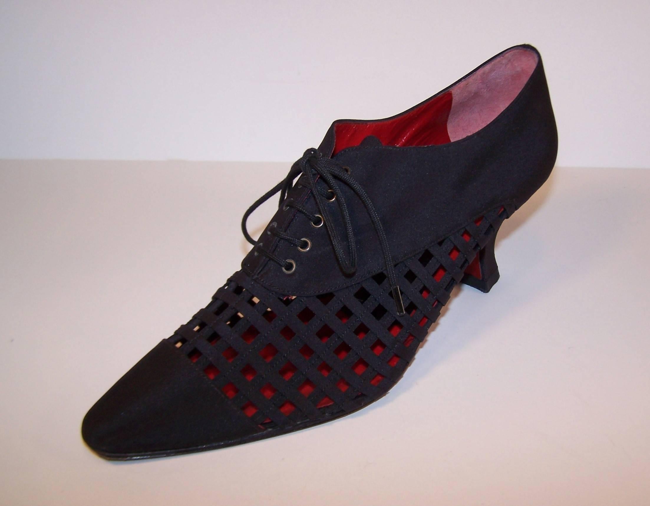 These Charles Jourdan shoes are a great combination of a Louis IV style silhouette and 1930's ladies oxford.  They lace at the vamp with comfortably curved Louis IV heel and a latticed cage design all in a heavy black silk.  The interior foot bed