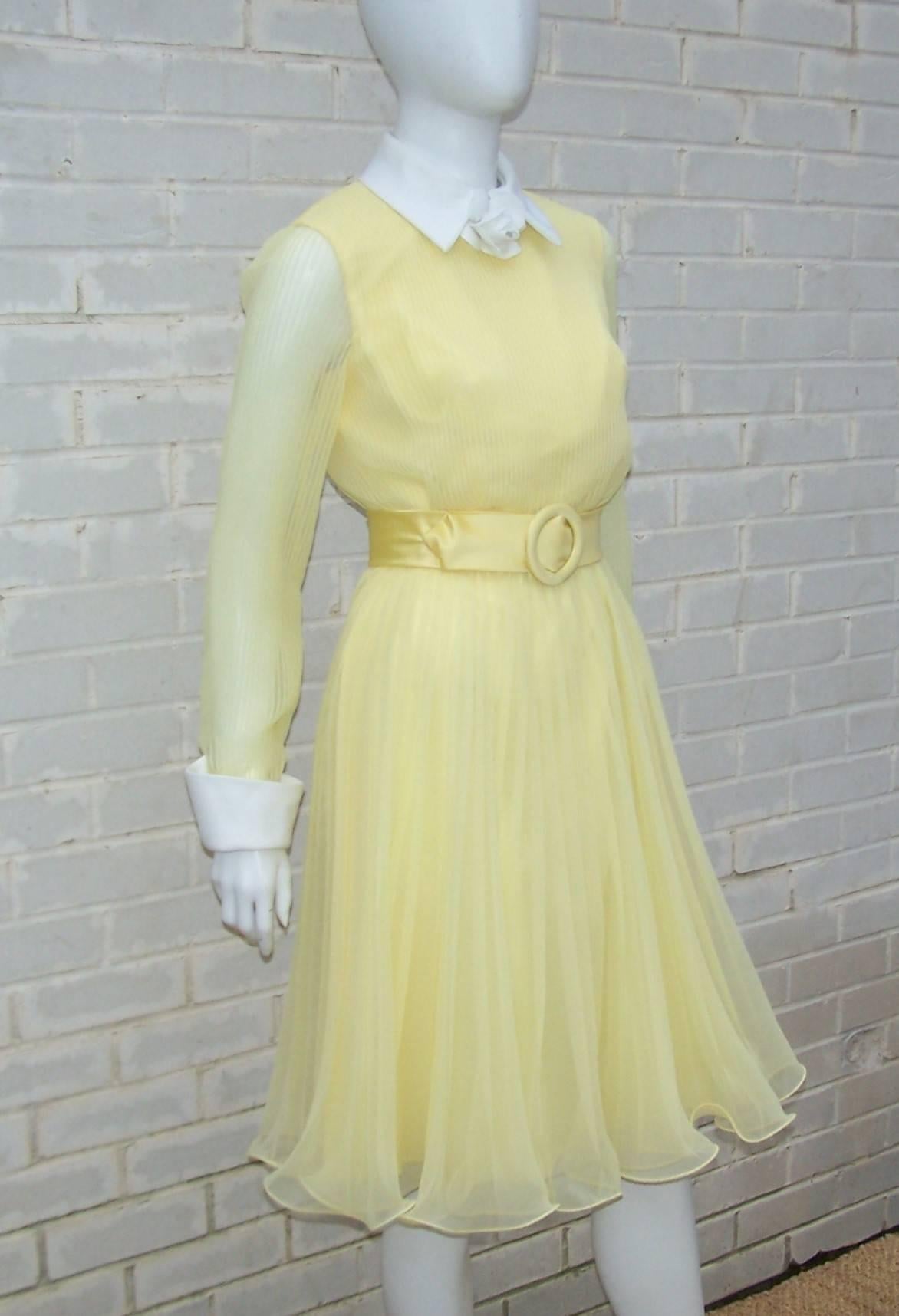 Elliette Ellis loved using chiffon fabrics to express a romantic femininity in her designs.  This lovely C.1970 yellow dress is reminiscent of buttercups with micro pleating throughout the bodice and knife pleats in the flouncy skirt.  The hemline