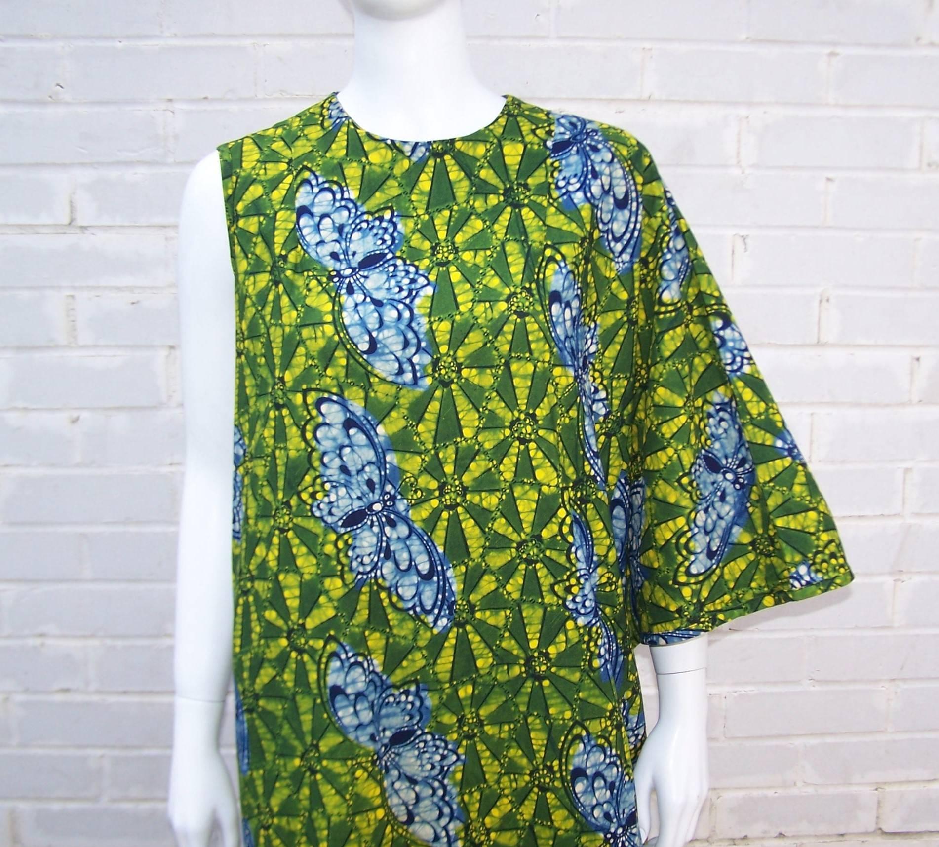 This asymmetrical caftan is a great combination of glamour and 1960's psychedelia all wrapped up in a colorful batik printed cotton fabric.  The lush greens, yellows and blue colors are reminiscent of a tropical rain forest and the design also