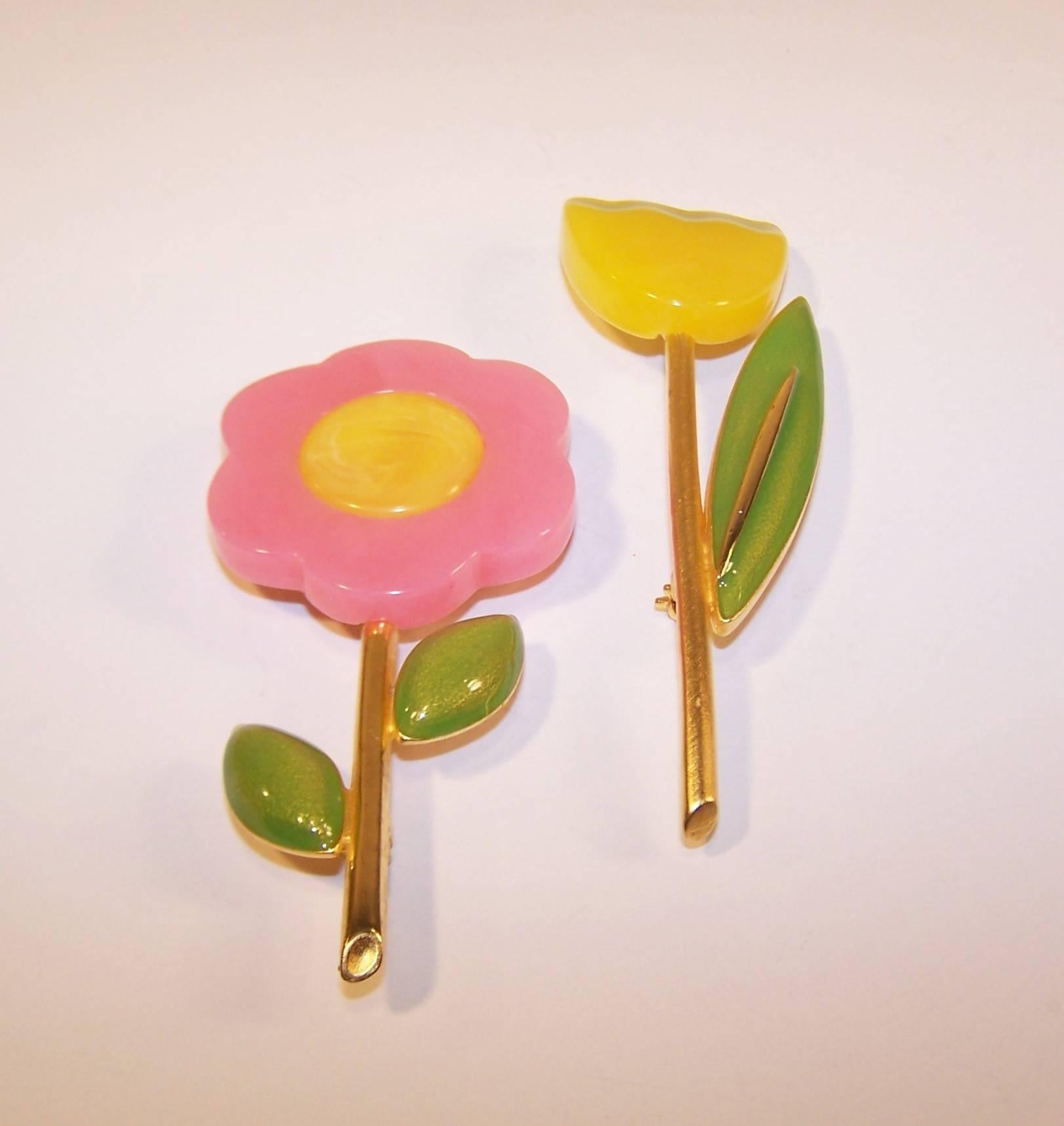 Much like his lovely clothing designs, Hubert de Givenchy created elegant and feminine costume jewelry starting in the 1950's and throughout his career.  This pair of flower brooches are made from pastel resin in yellow, pink and green with
