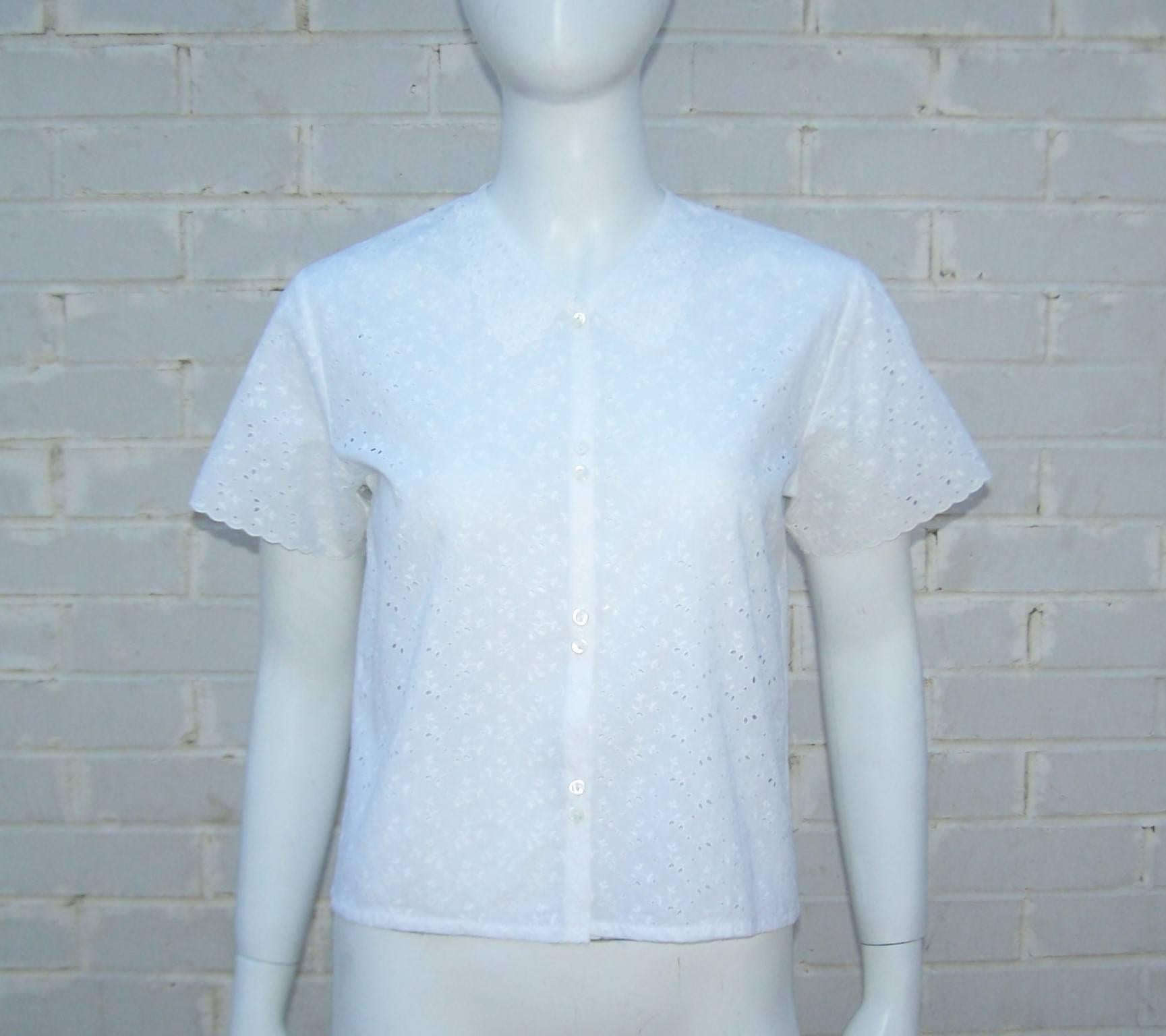 This simple white cotton eyelet top by Cacharel is loaded with charm and perfect for a warm weather wardrobe.  It buttons at the front with scalloped sleeves and a boxy cropped silhouette.  Pair it with high waist jeans and flat sandals for an easy